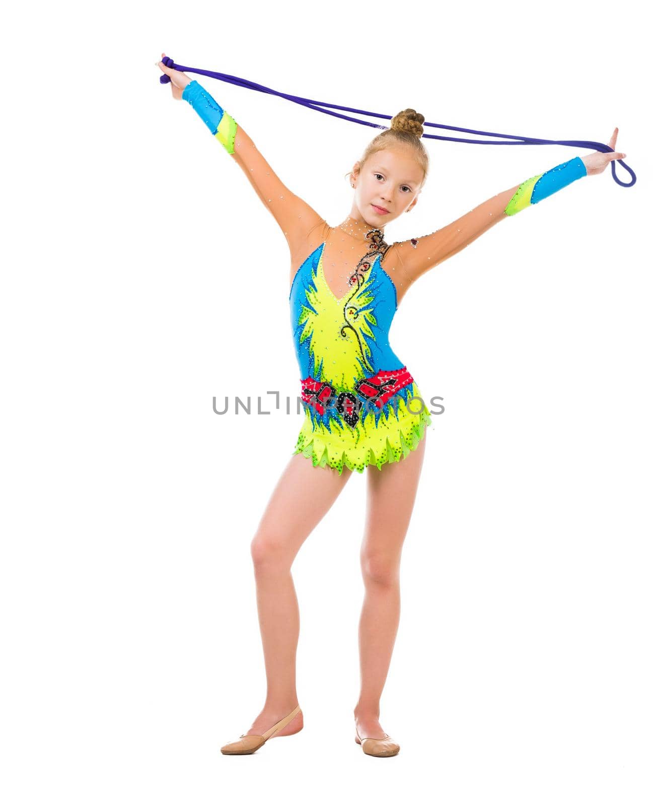 little gymnast holding a skipping rope over her head isolated on white background