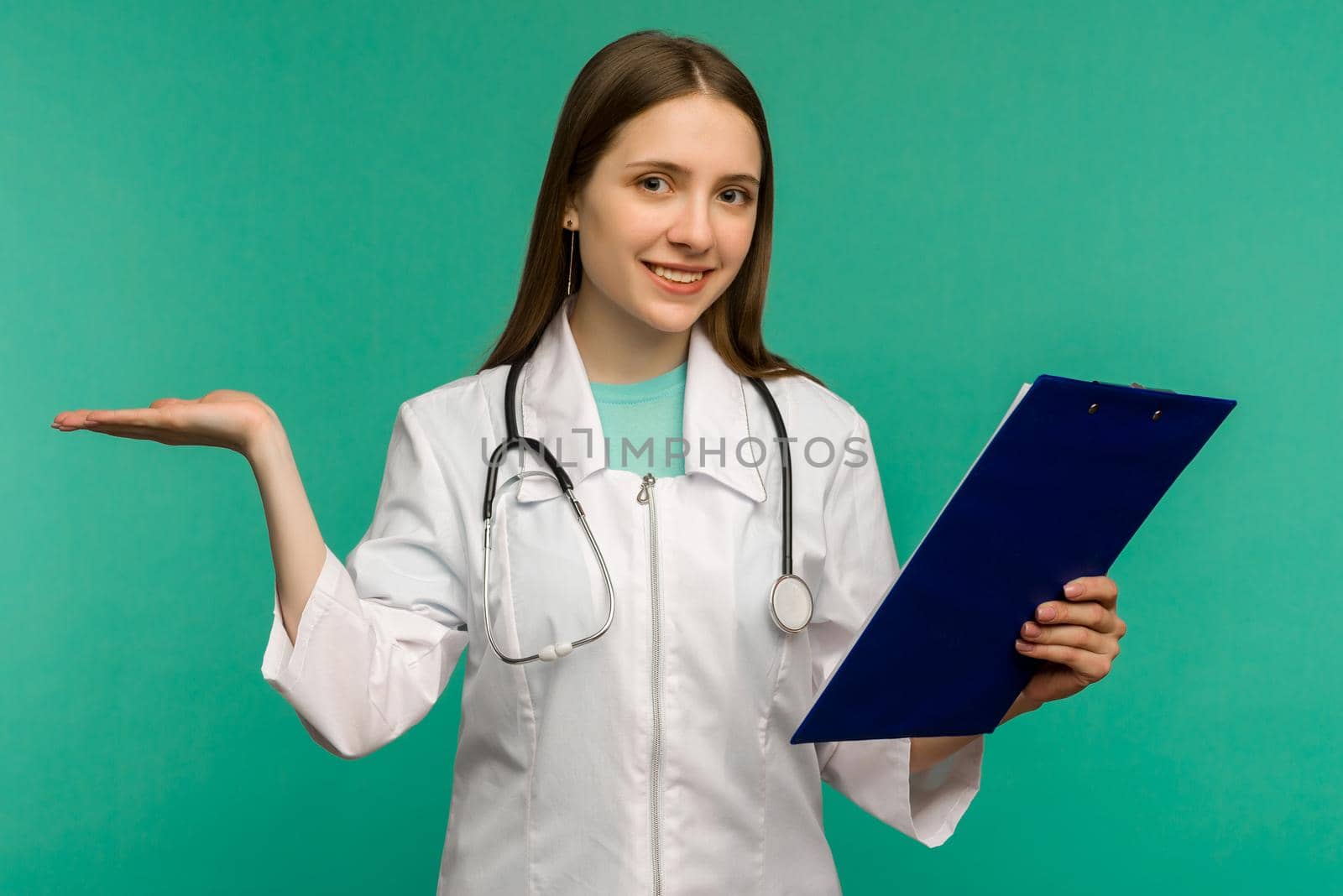 Happy smiling young female doctor with clipboard, isolated over background - image