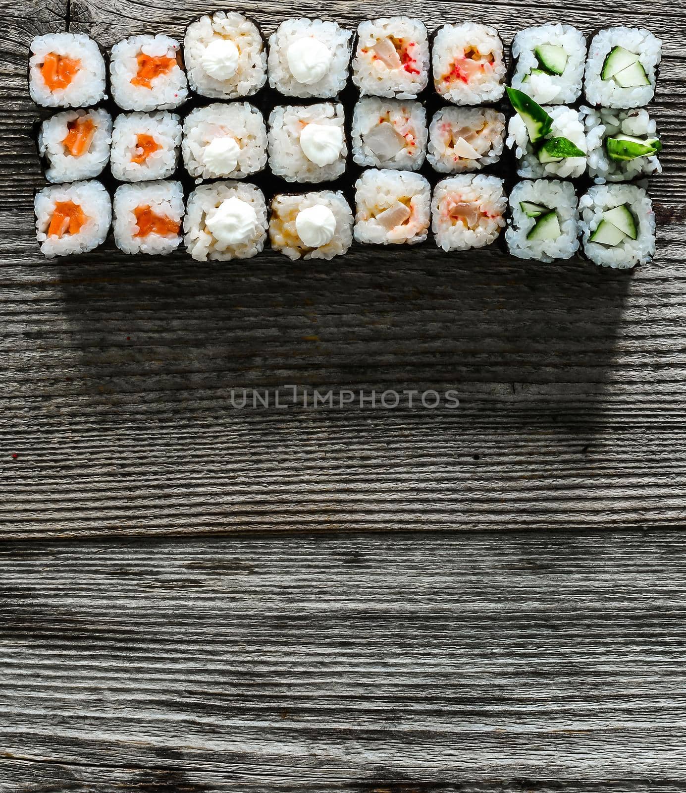 assorted set of shushi and a space for text on wooden background