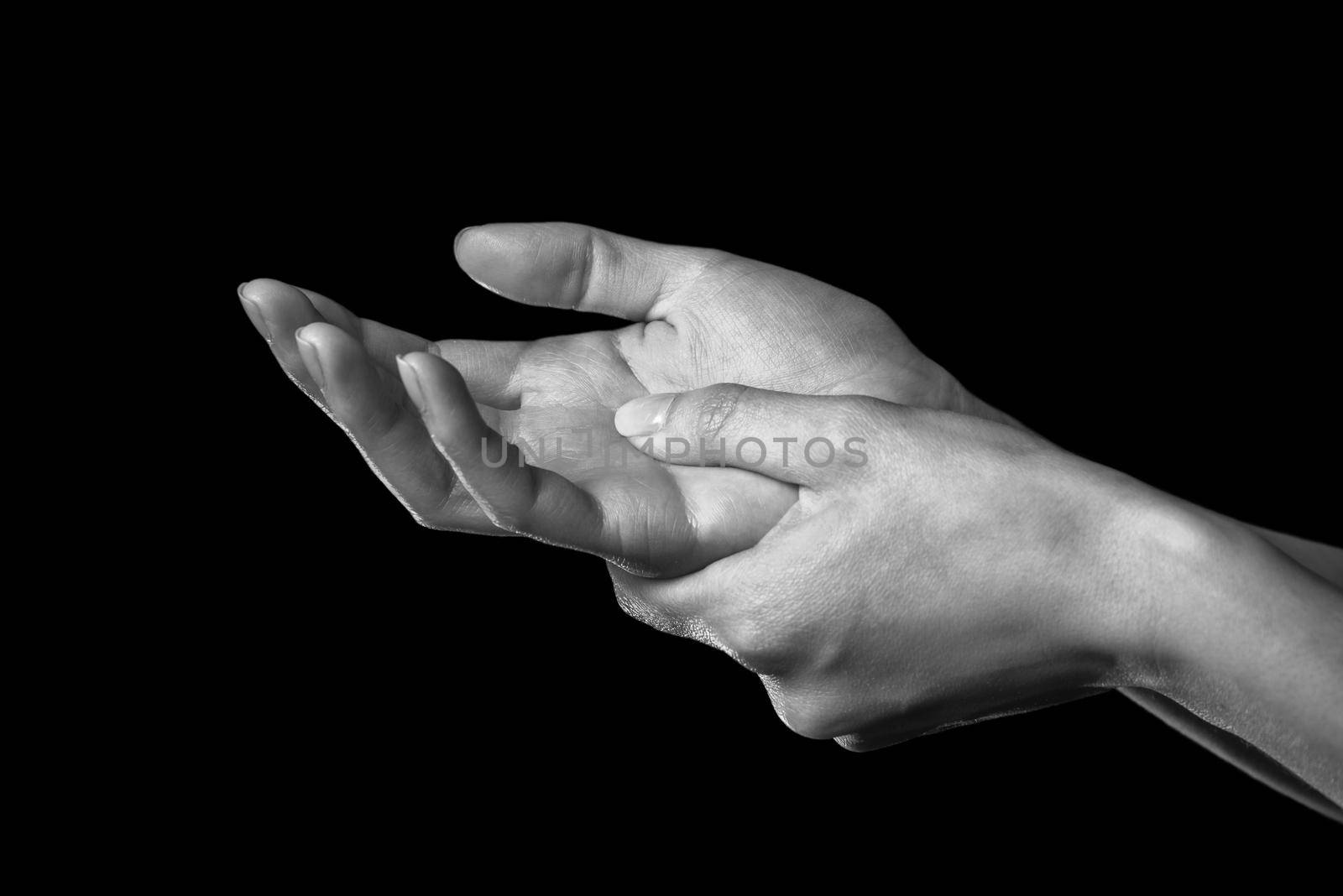 Woman holds her hand, pain in the wrist, black and white image