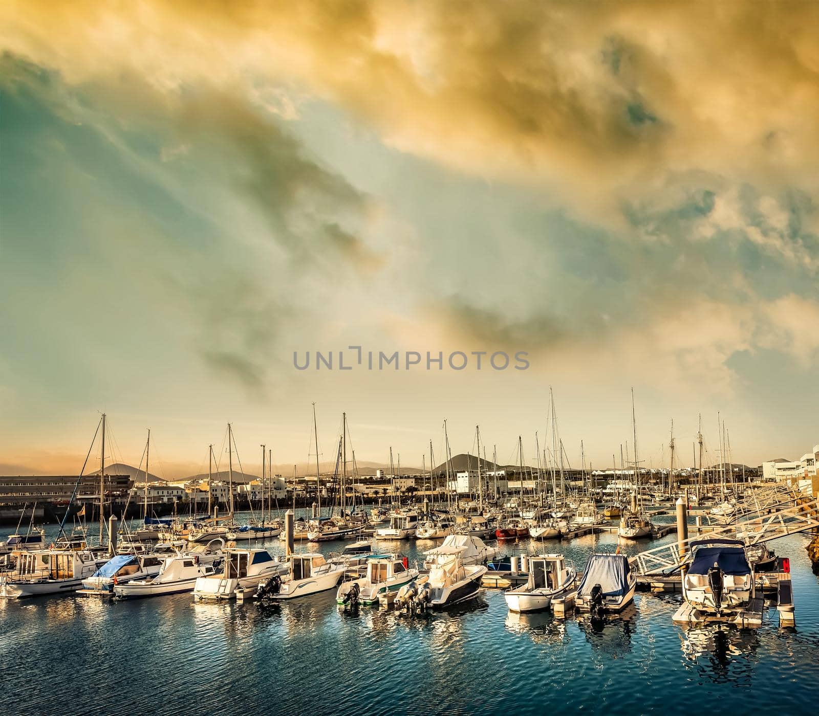 yachts in bay near a city at sunset