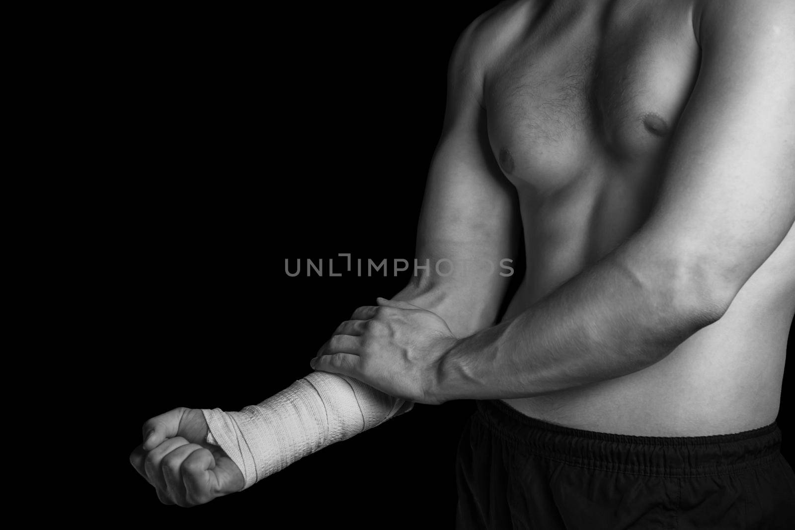 Pain in a male wrist, bandaged hand, monochrome image