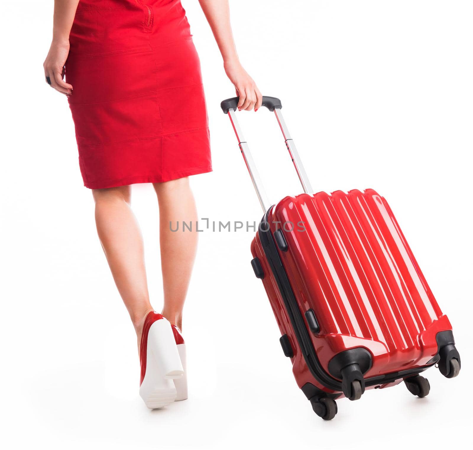 legs of girl going away with suitcase