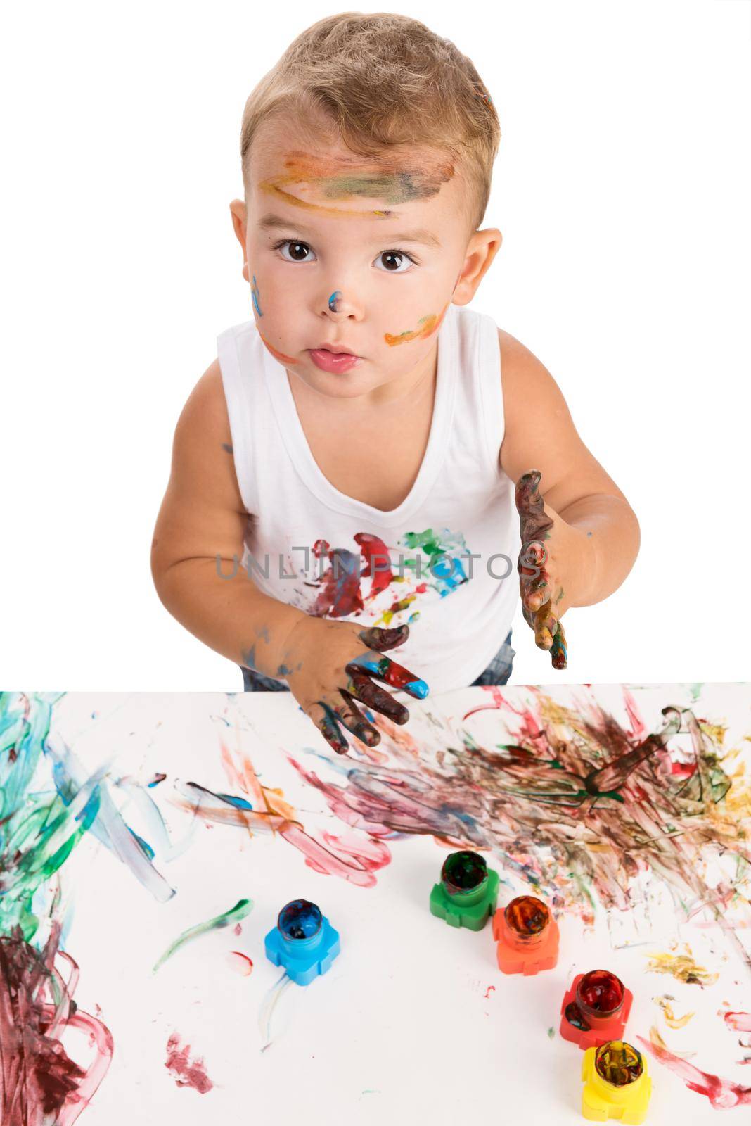 funny little boy painting with hands paper and himself on a white background