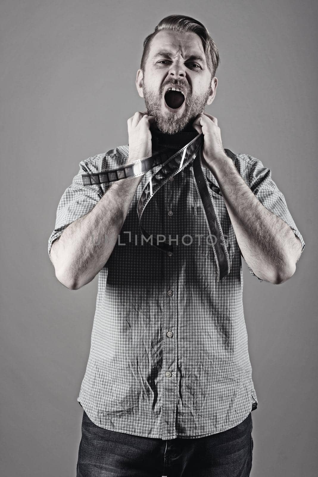 an angry man screams with a film on his neck.