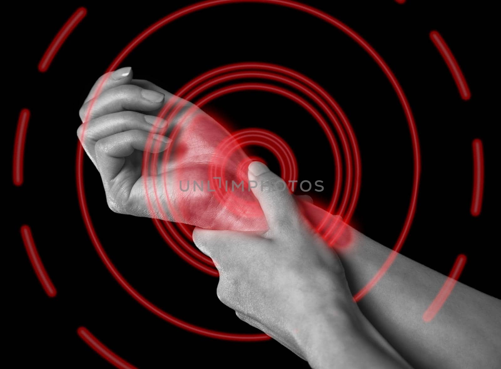 Unrecognizable woman holds her hand, pain in the wrist, monochrome image, pain area of red color