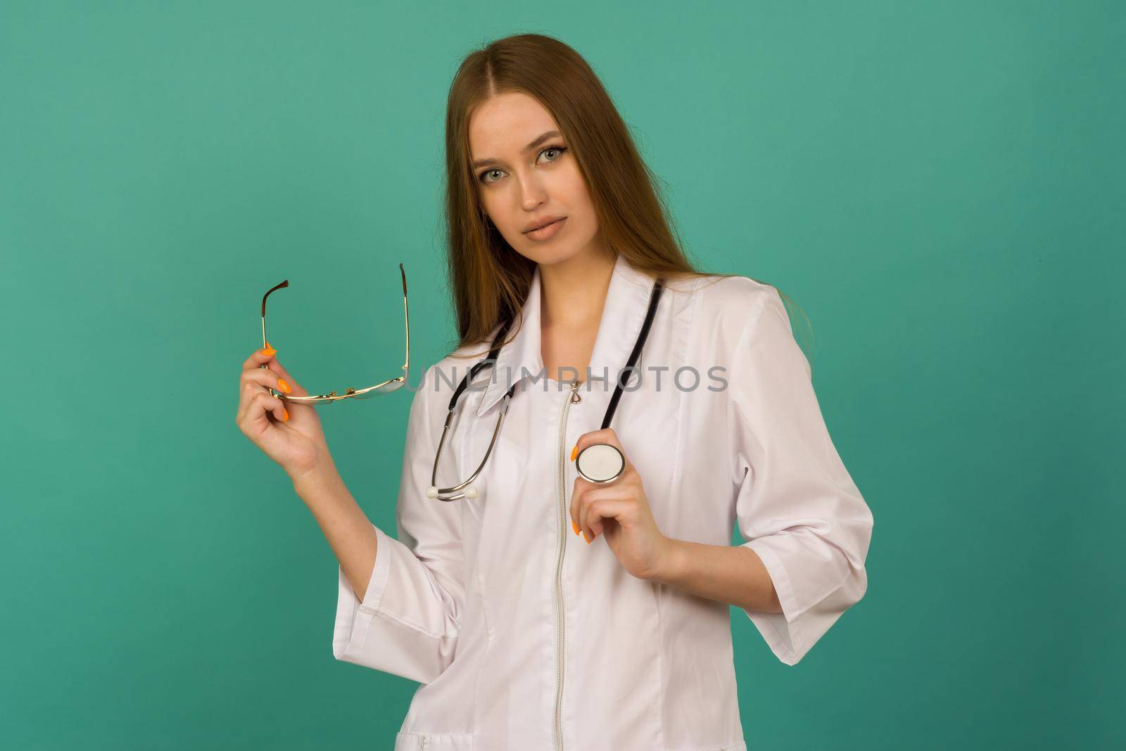 Beautiful smiling sexy nurse or femele doctor standing isjlated on background . Looking at camera. by zartarn