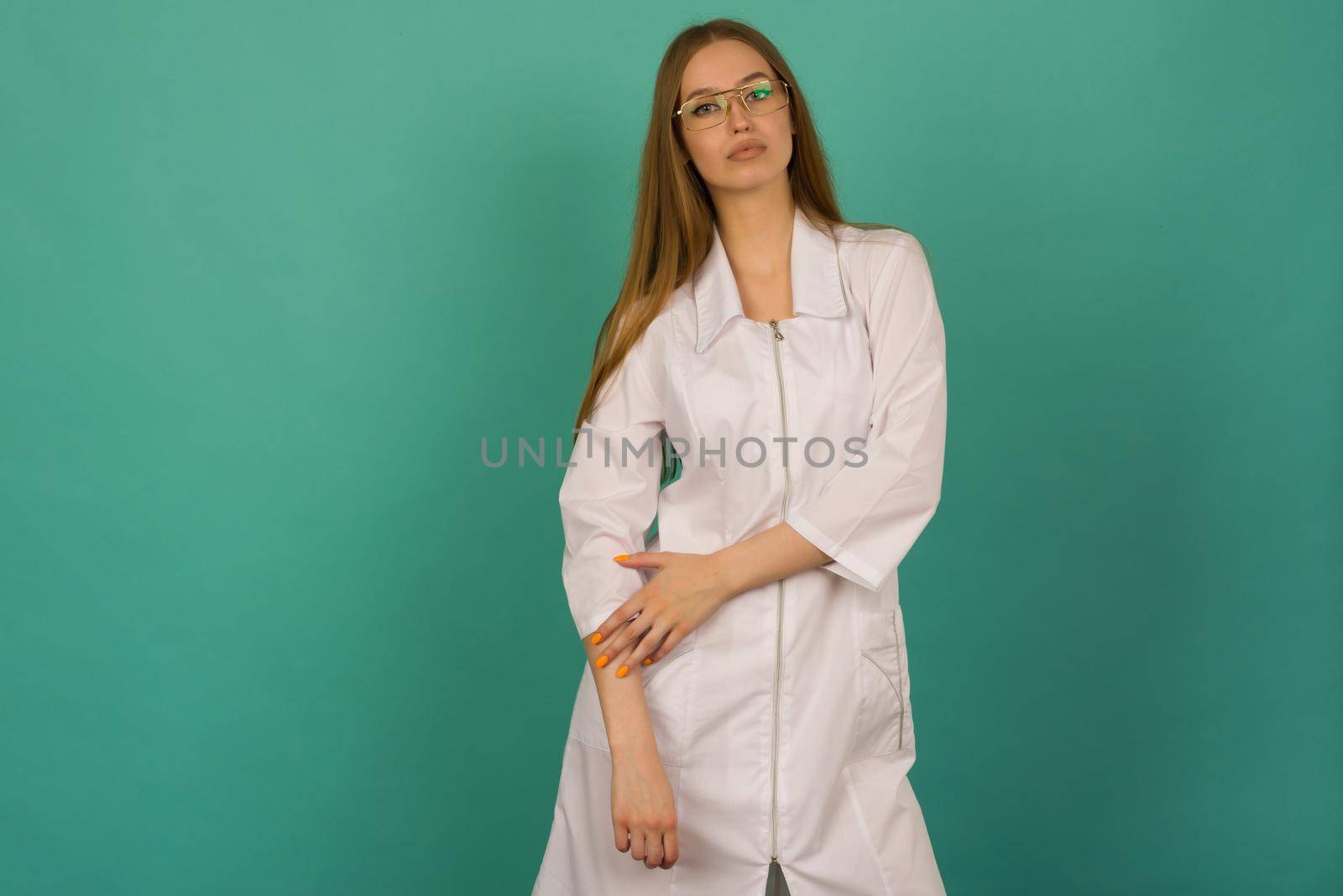 Beautiful smiling sexy nurse or femele doctor standing isjlated on background .