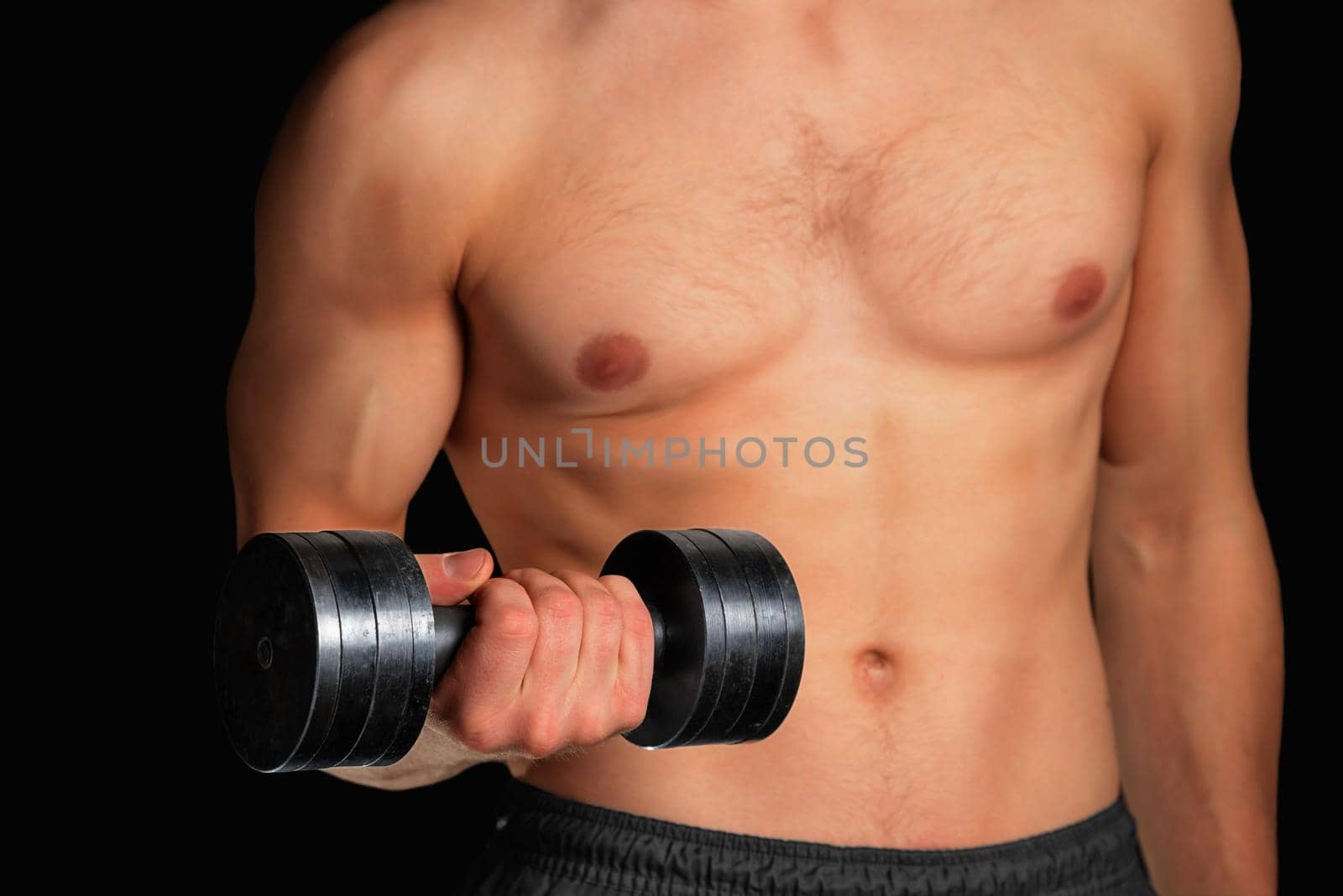 Muscular sportsman exercises with metal dumbbell, fitness, face is not visible