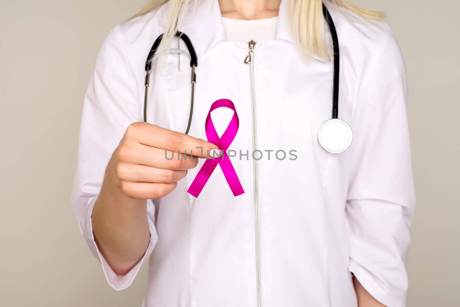 Female Doctor Holds Pink Ribbon, International Breast Cancer Day October 7 - Image