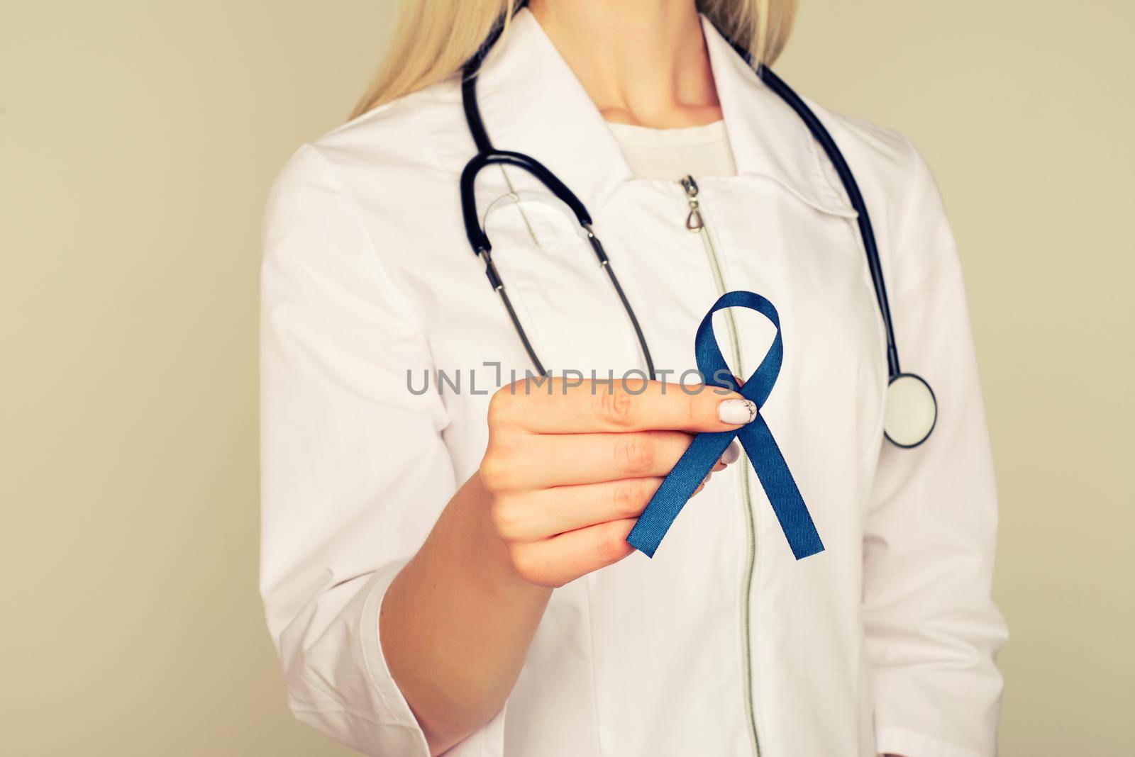 Doctor hands holding blue ribbon, diabetes and Colorectal Cancer Awareness - Image