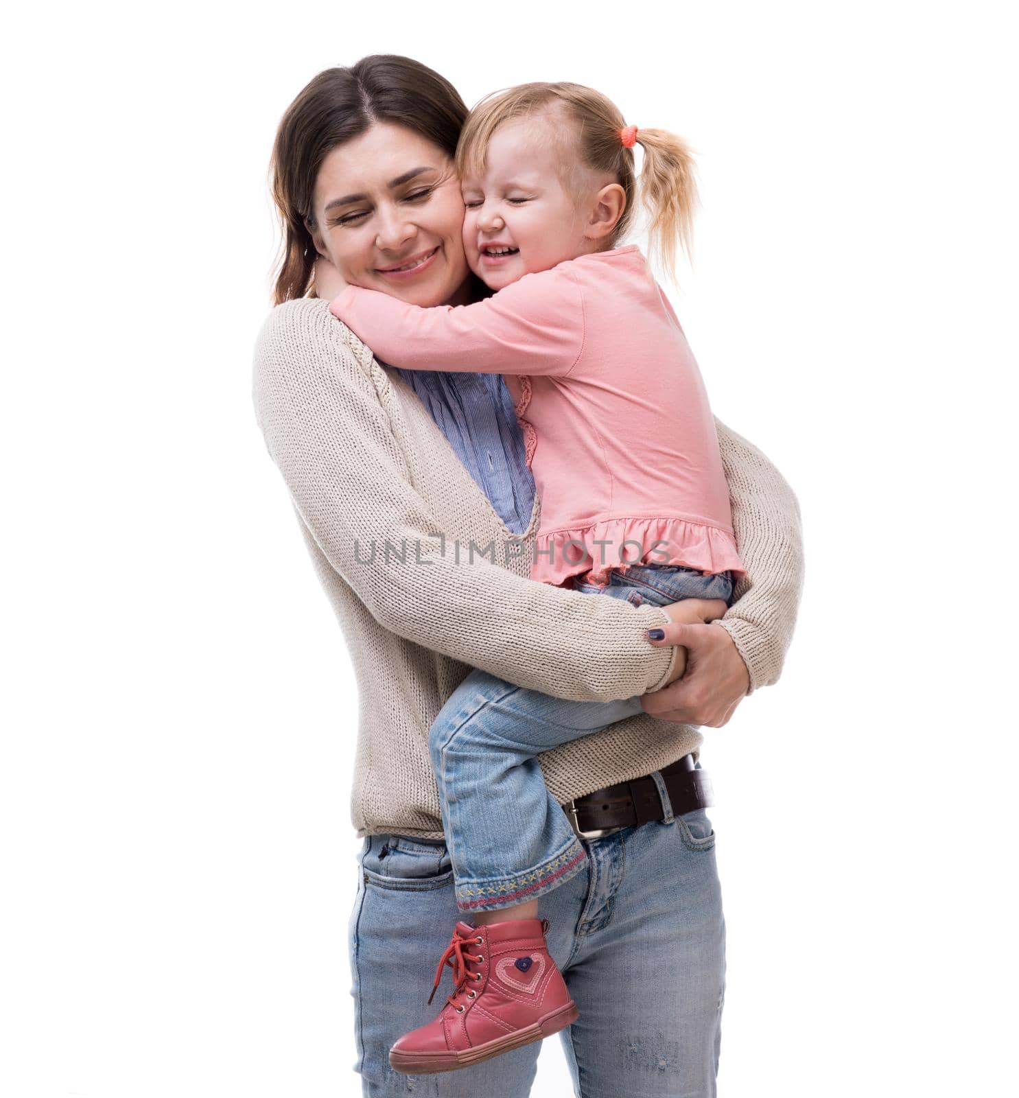 mother with little daughter in her arms hugging isolated on white background