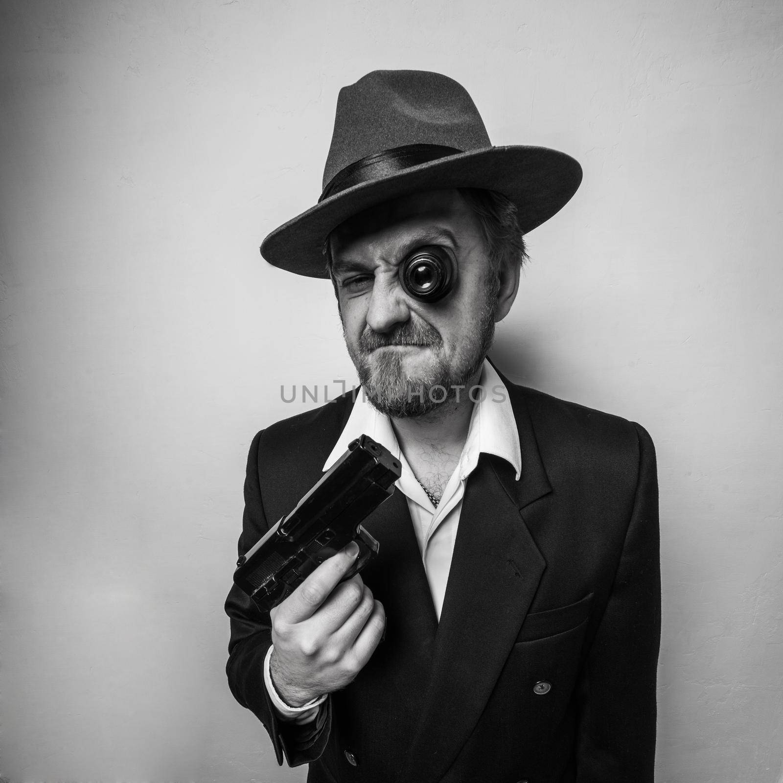 crazy beard detective whit gun in hat at white background