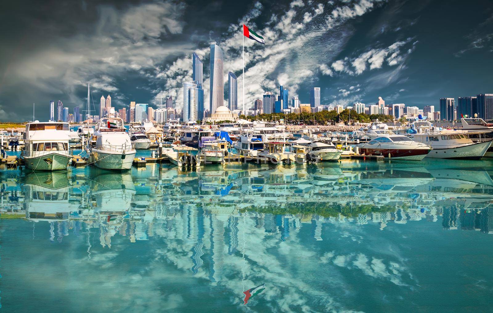 quay with yachts and skyscrapers in Abu Dhab against blue sky