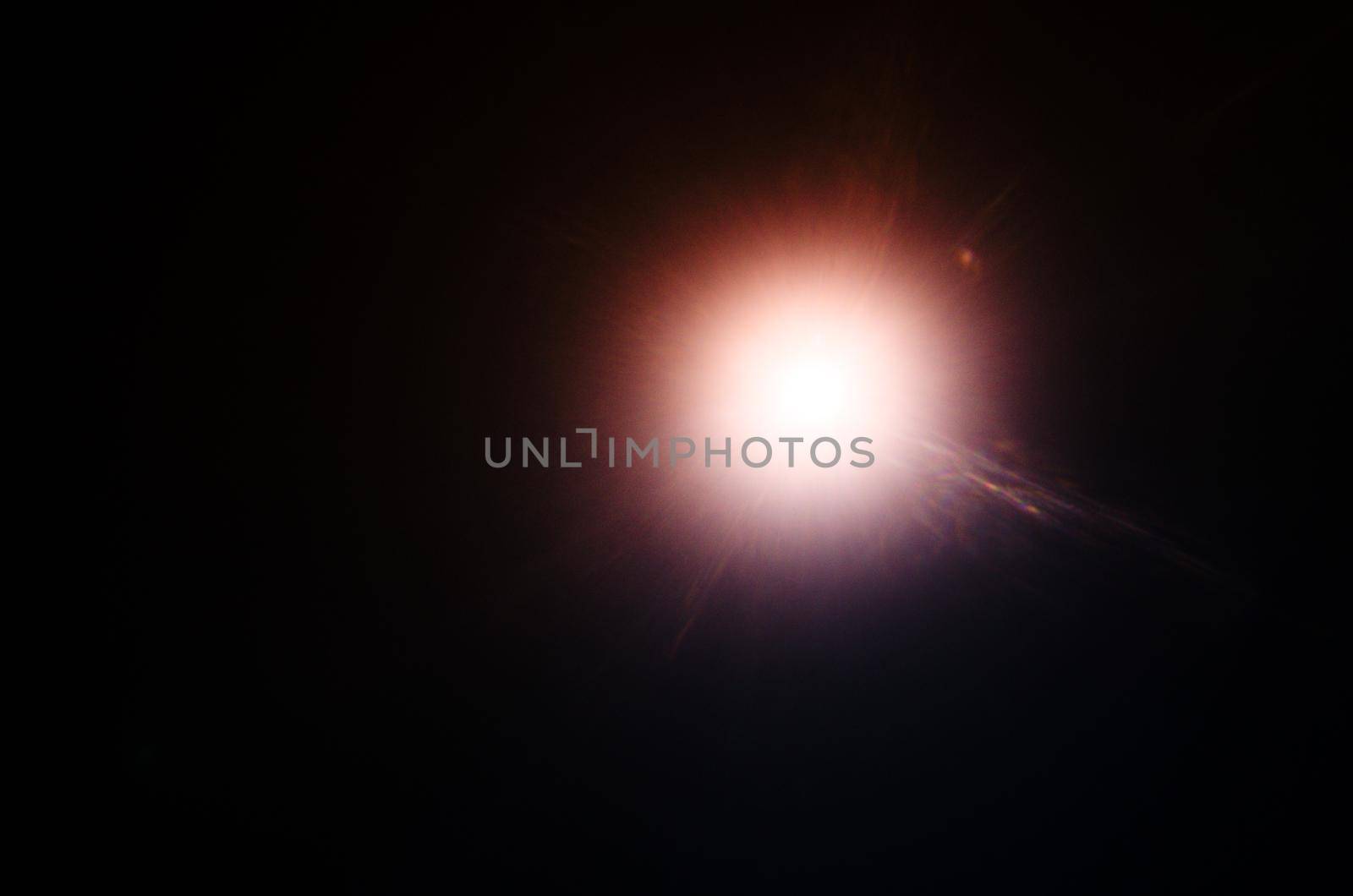Abstract Natural Sun flare or Far star on the black background - image