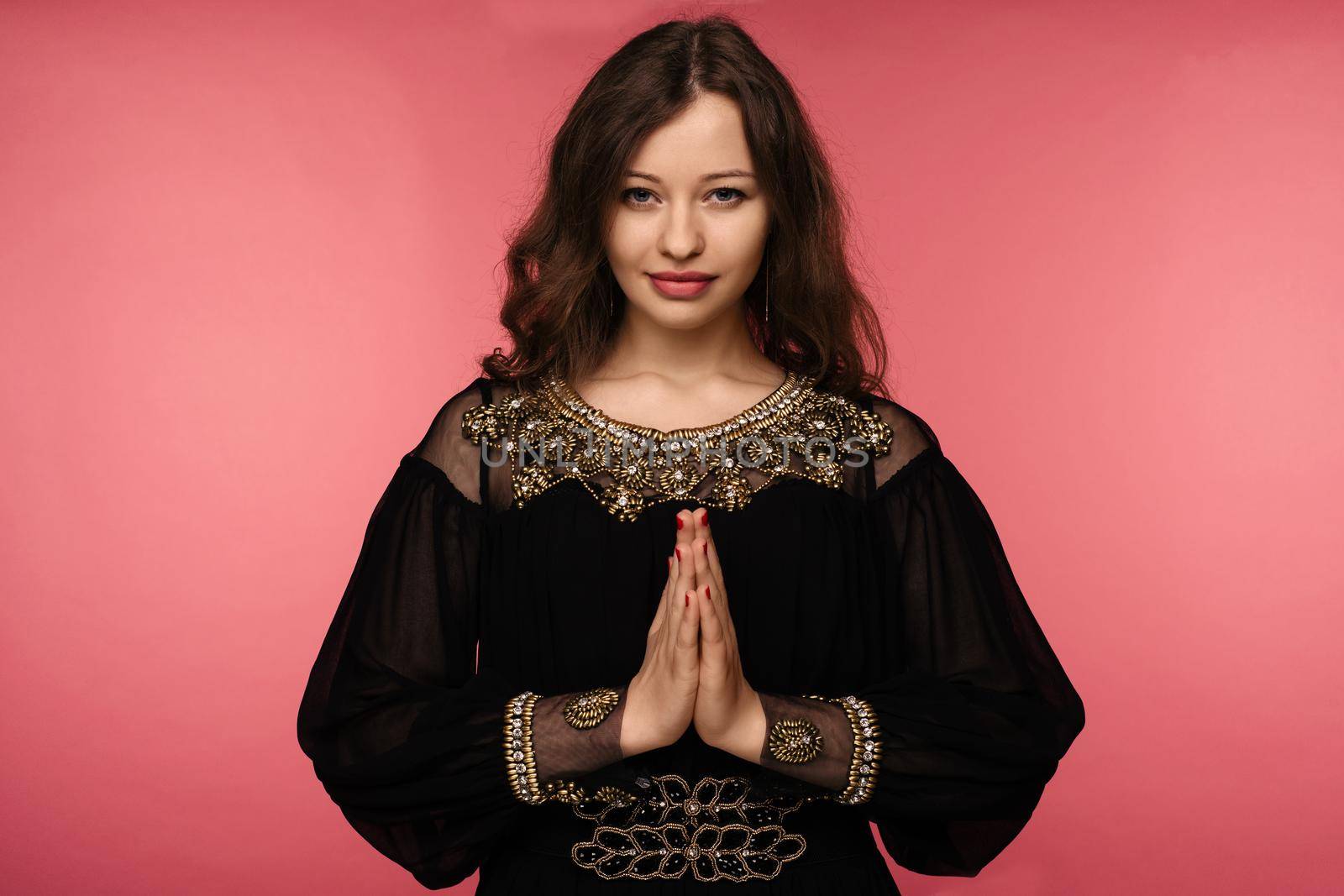 woman practicing yoga, holding palms together in namaste mudra, relaxed and peaceful. - Image