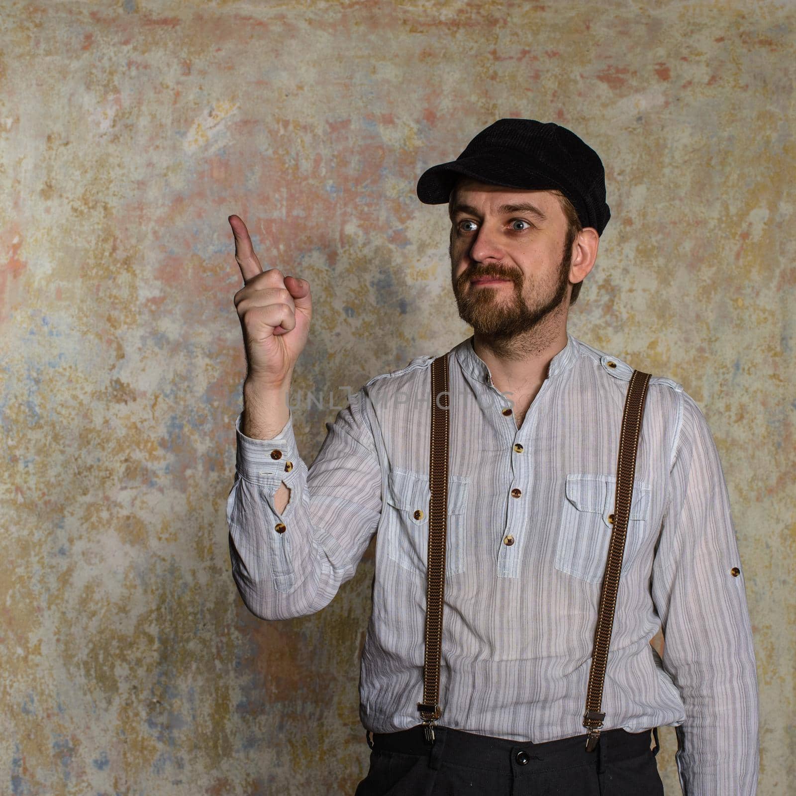 Excited man pointing a great idea adjusting his suspenders