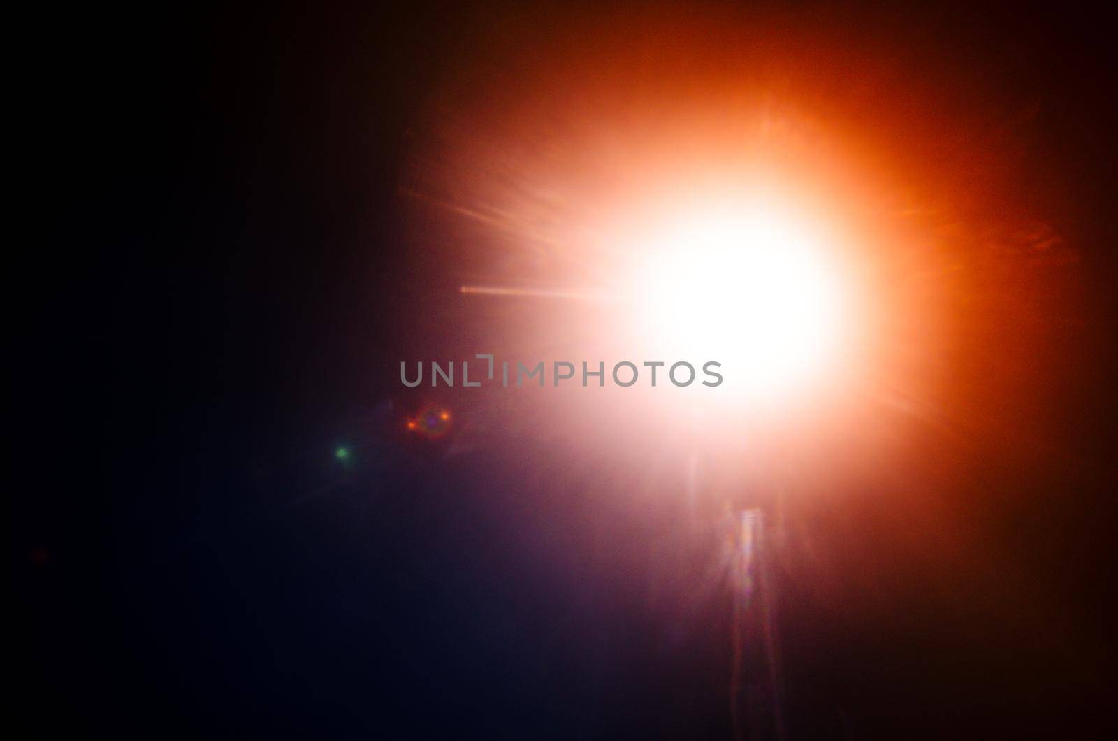 Abstract Natural Sun flare or Far star on the black background - image