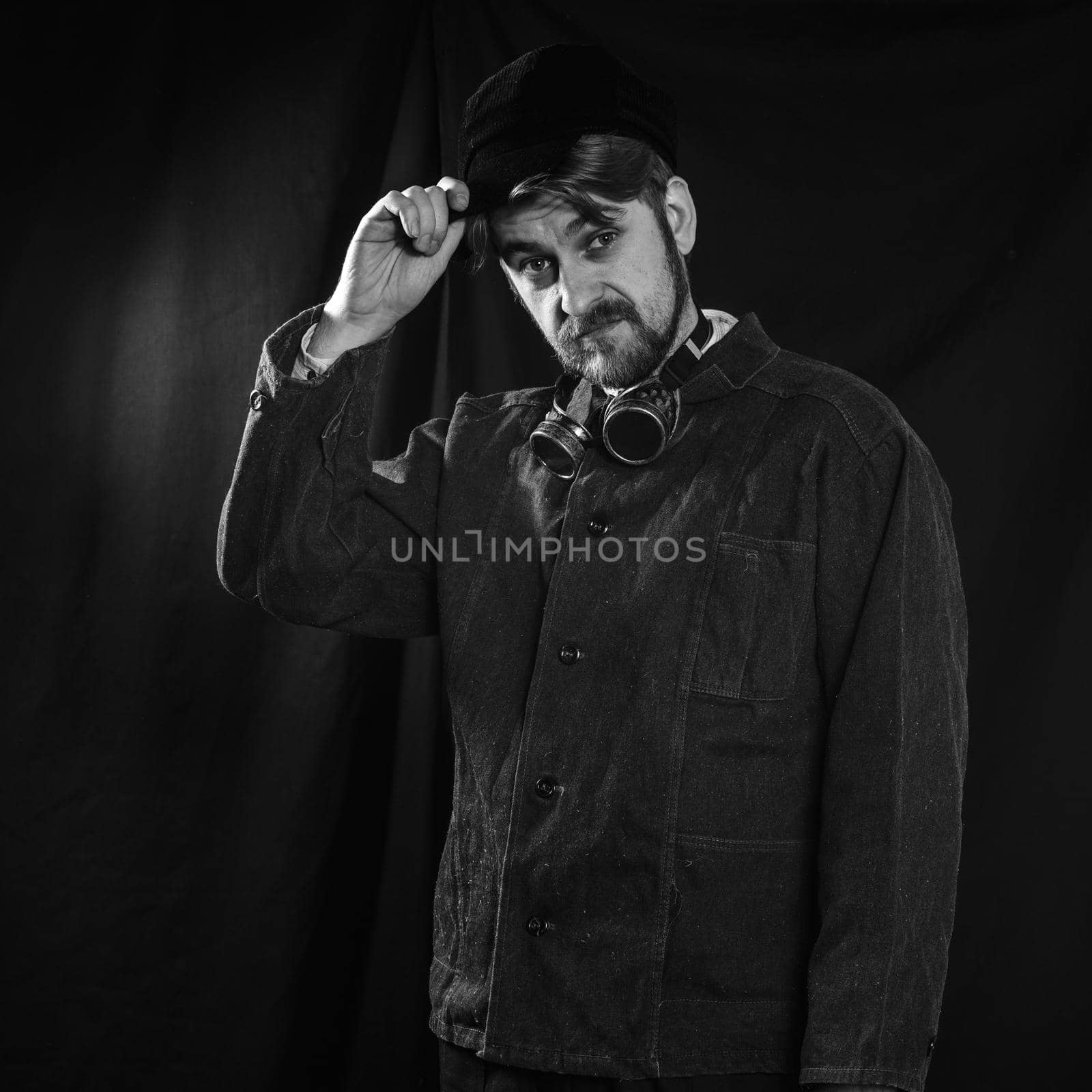 young beard worker welder take his cap