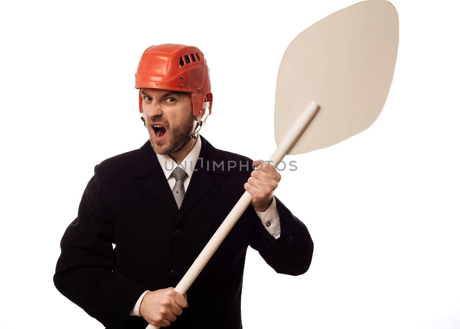 Dissatisfied businessman in a hockey helmet and with an oar in his hands on white background