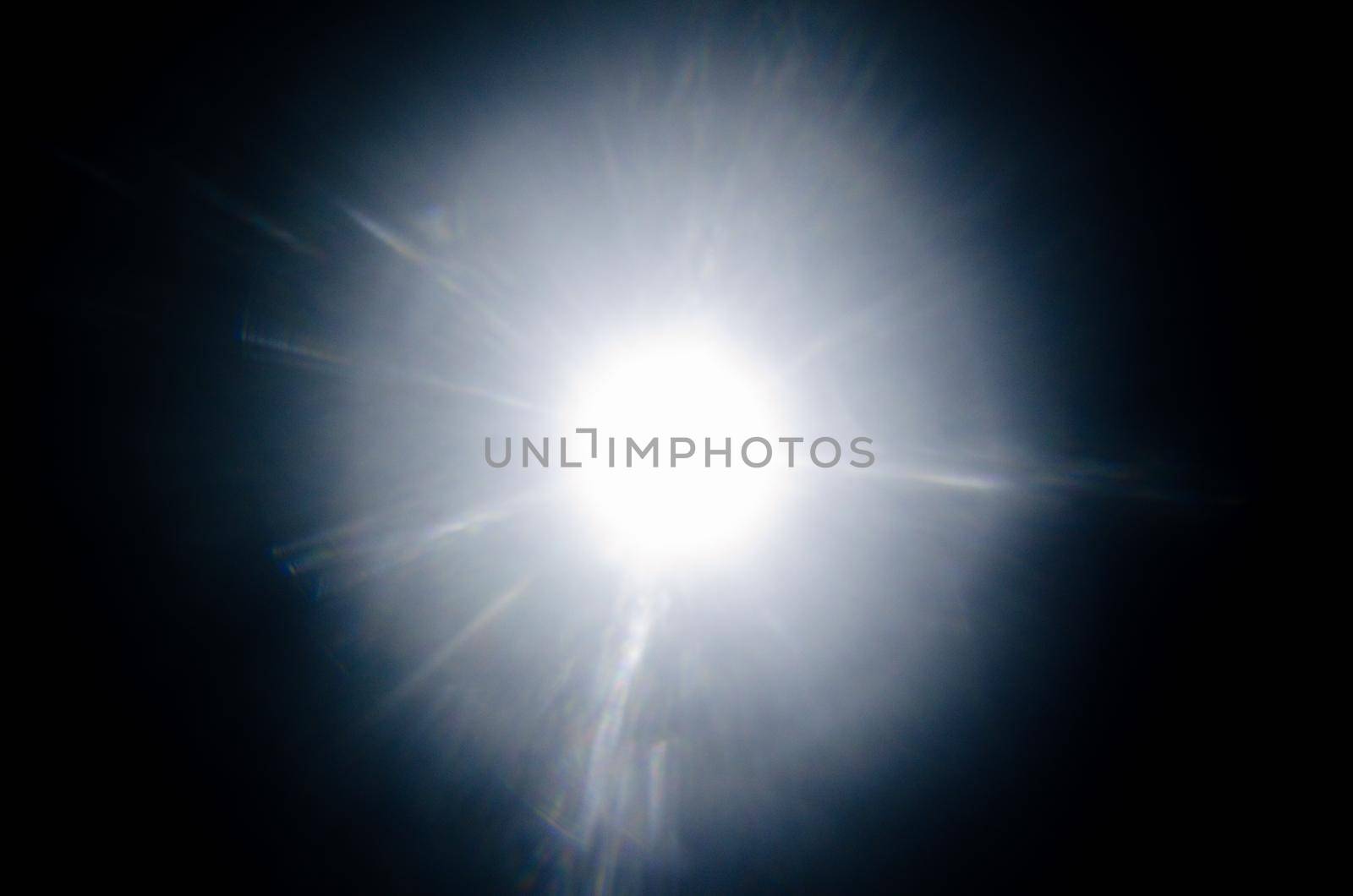 Abstract Natural Sun flare or Far star on the black background - image