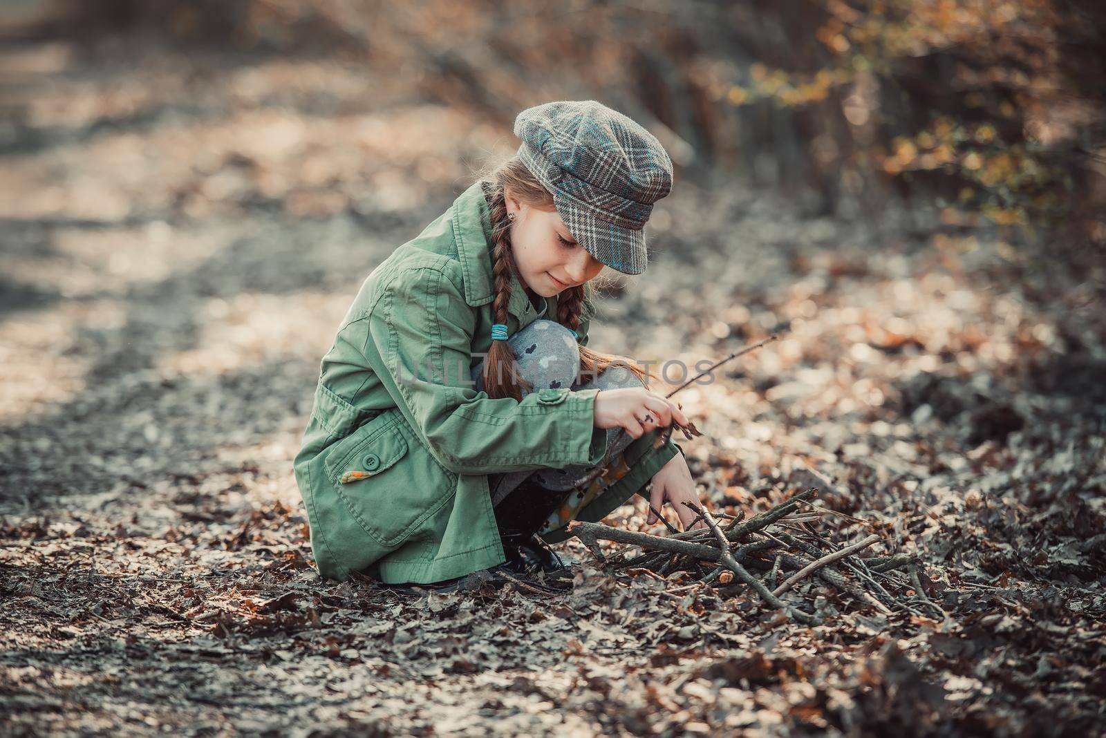 little girl making a bonfire, photo in vintage style