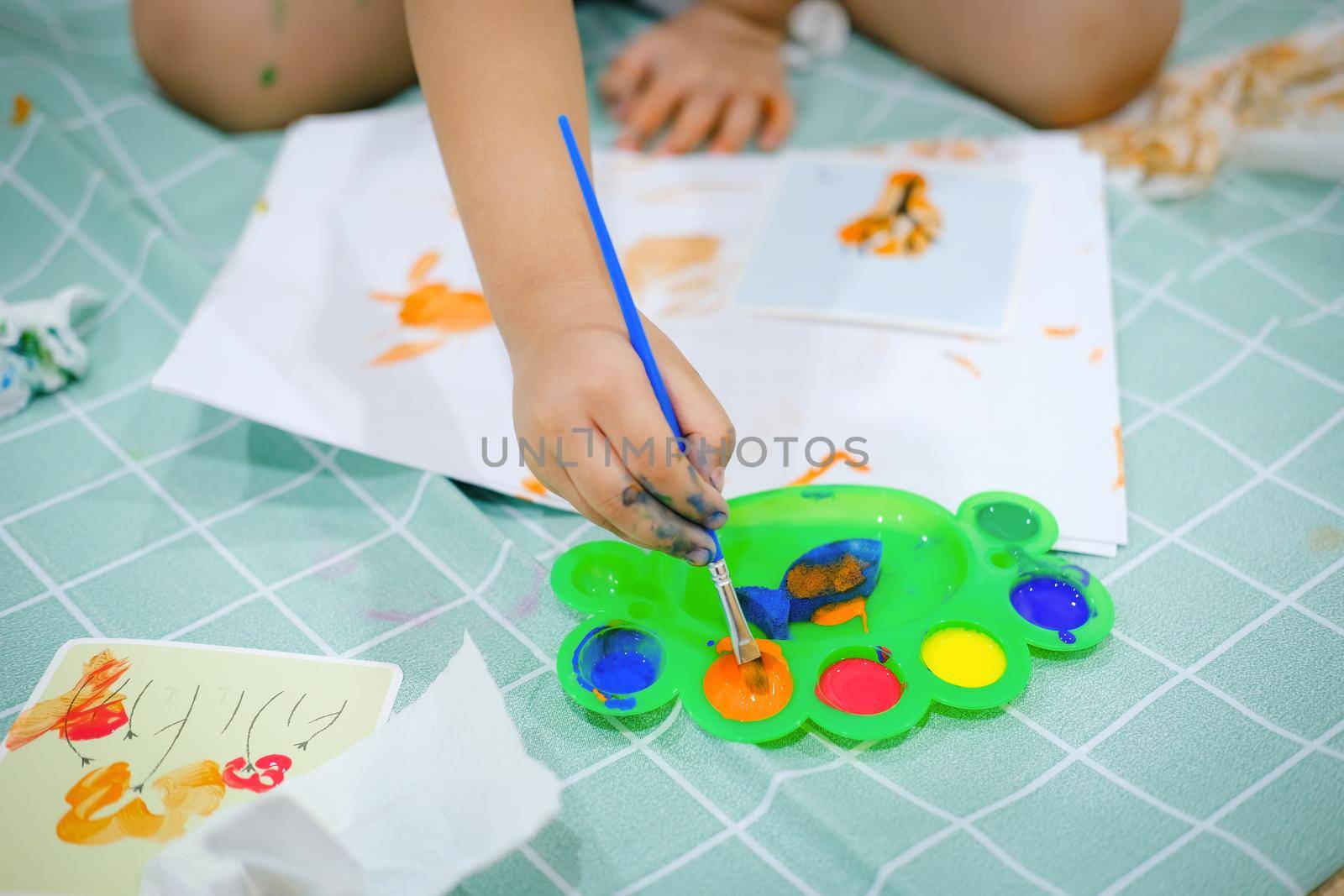 Children use watercolor brushes to create imagination and enhance their learning skills