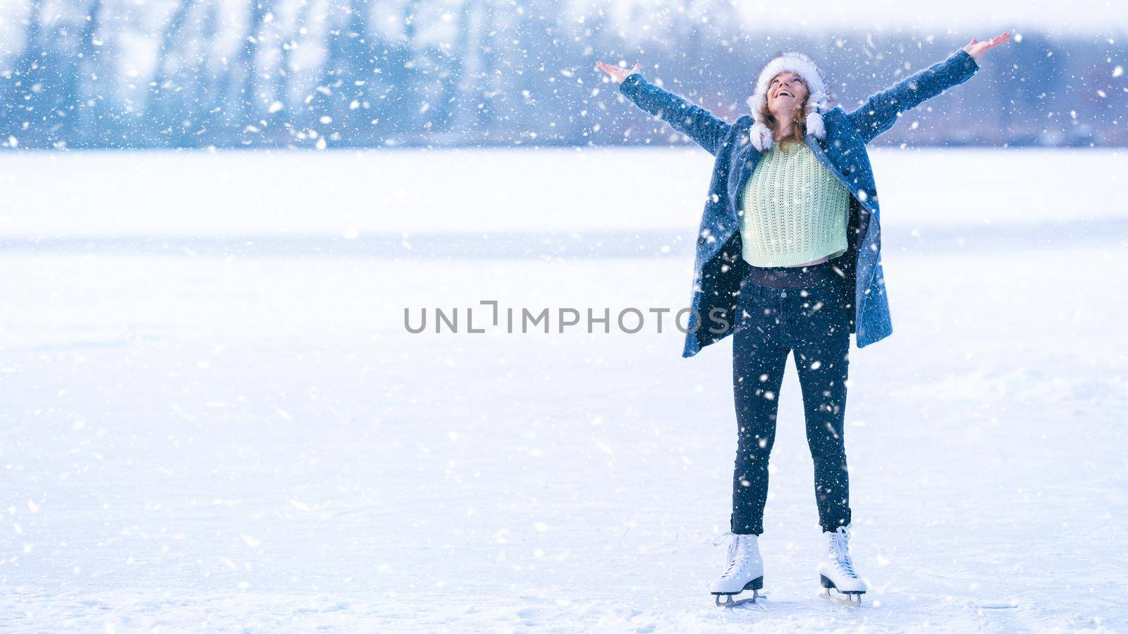 ice skating on a frozen pond in winter by Edophoto