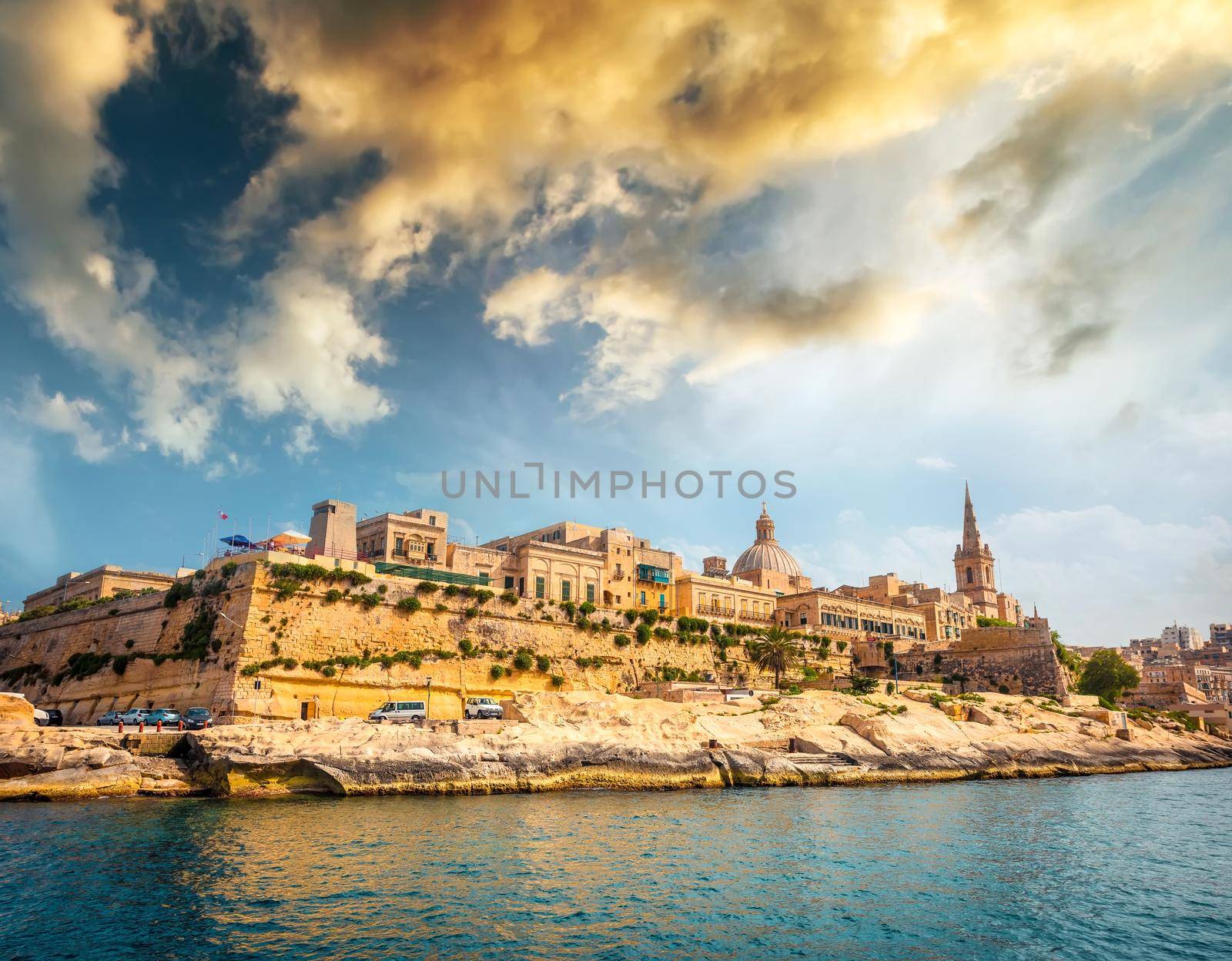 view on Valletta with its architecture from the sea at sunset