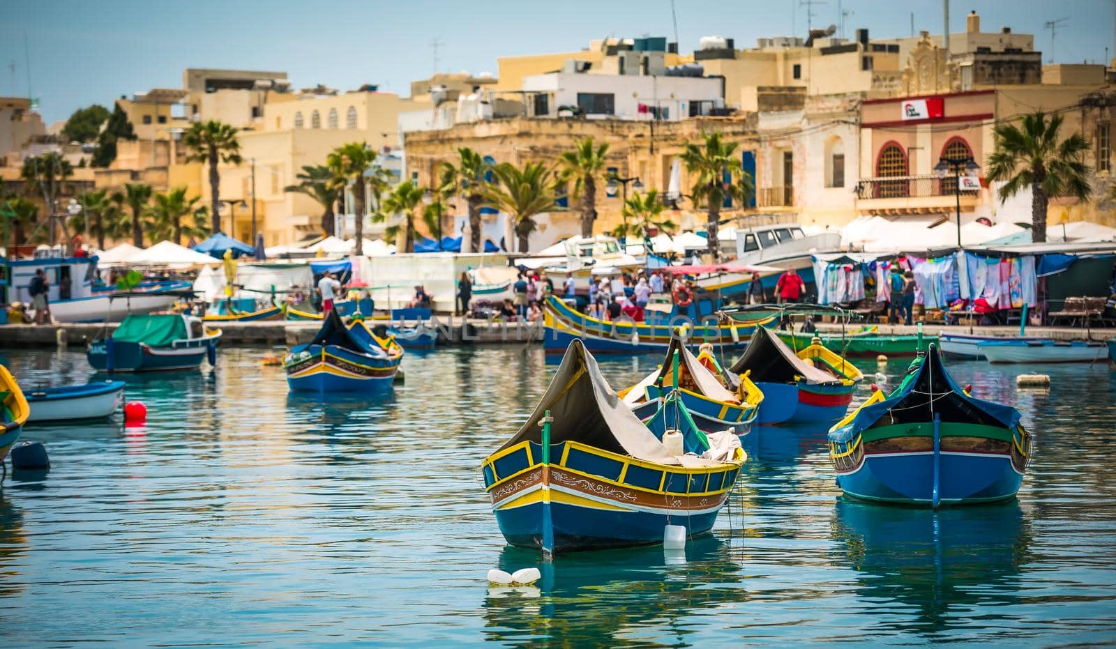 traditional fishing boats near market in fishing village of Marsaxlokk (Marsascala)