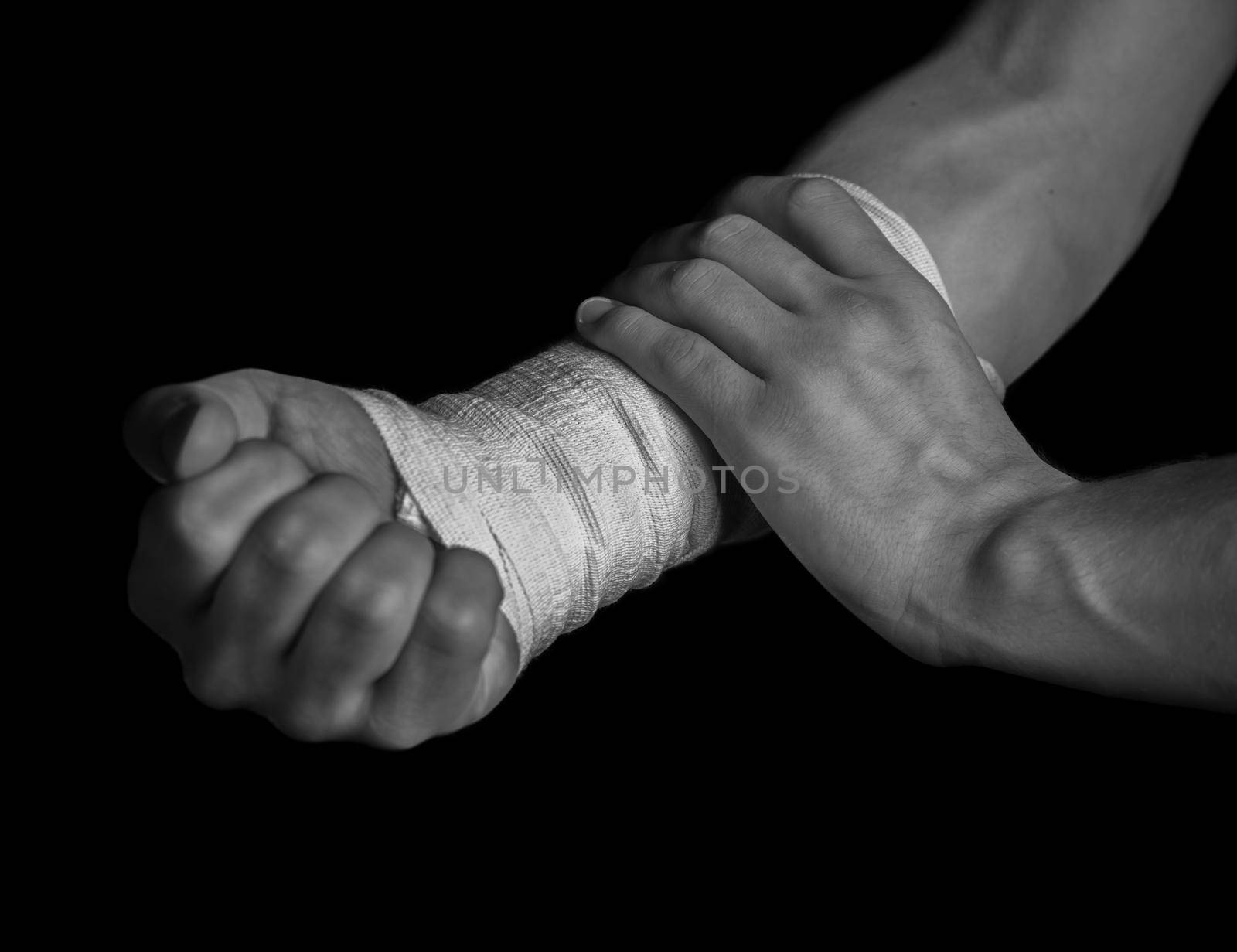 Pain in a male hand, bandaged hand, monochrome image