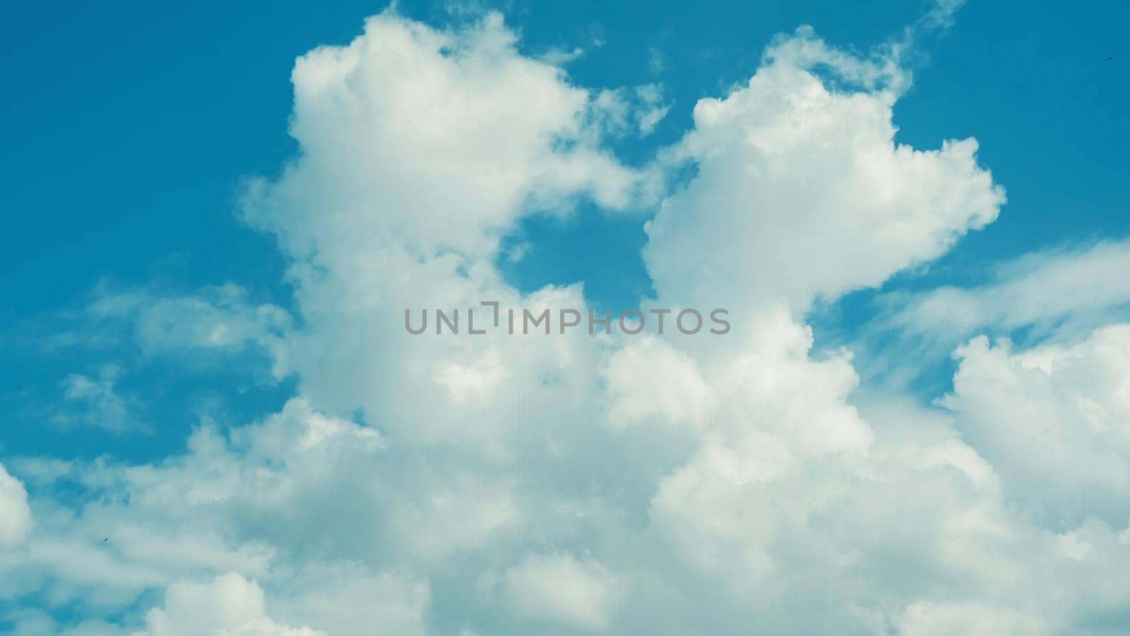 Blue sky background with clouds - image toned