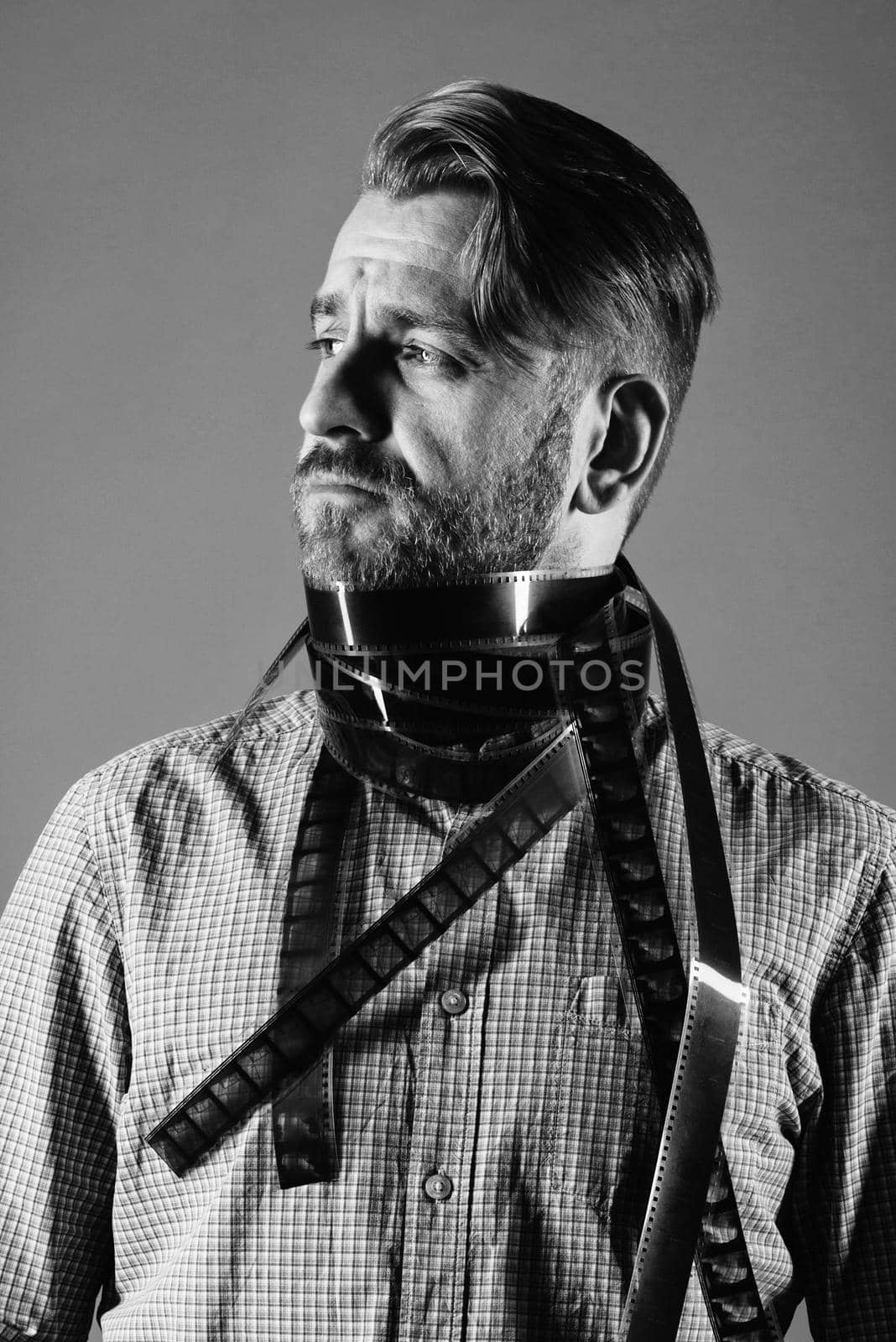 portrait of an attractive man in a scarf from an old photographic film in black and white photo