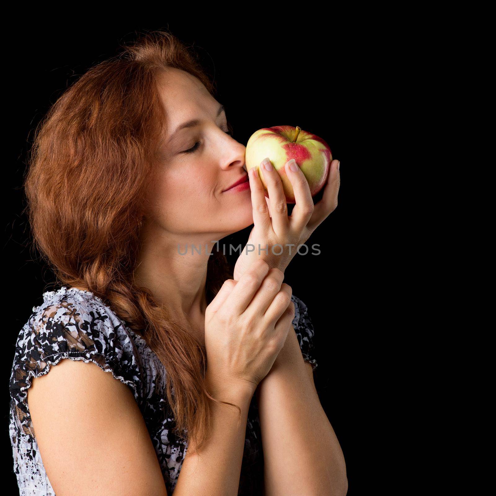 Joyful woman holding fresh apple by kolesnikov_studio