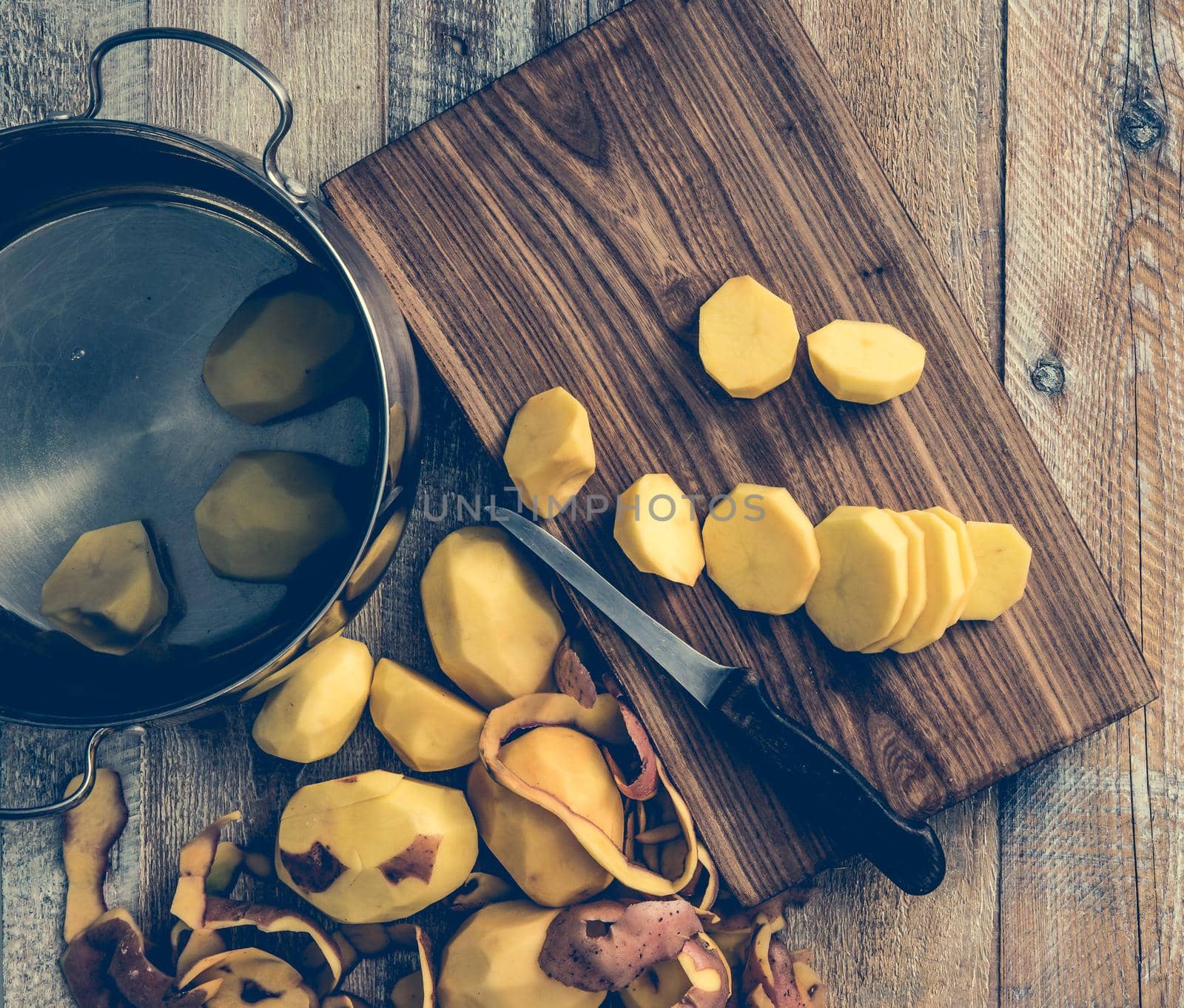 peeled and cut potato on wooden table