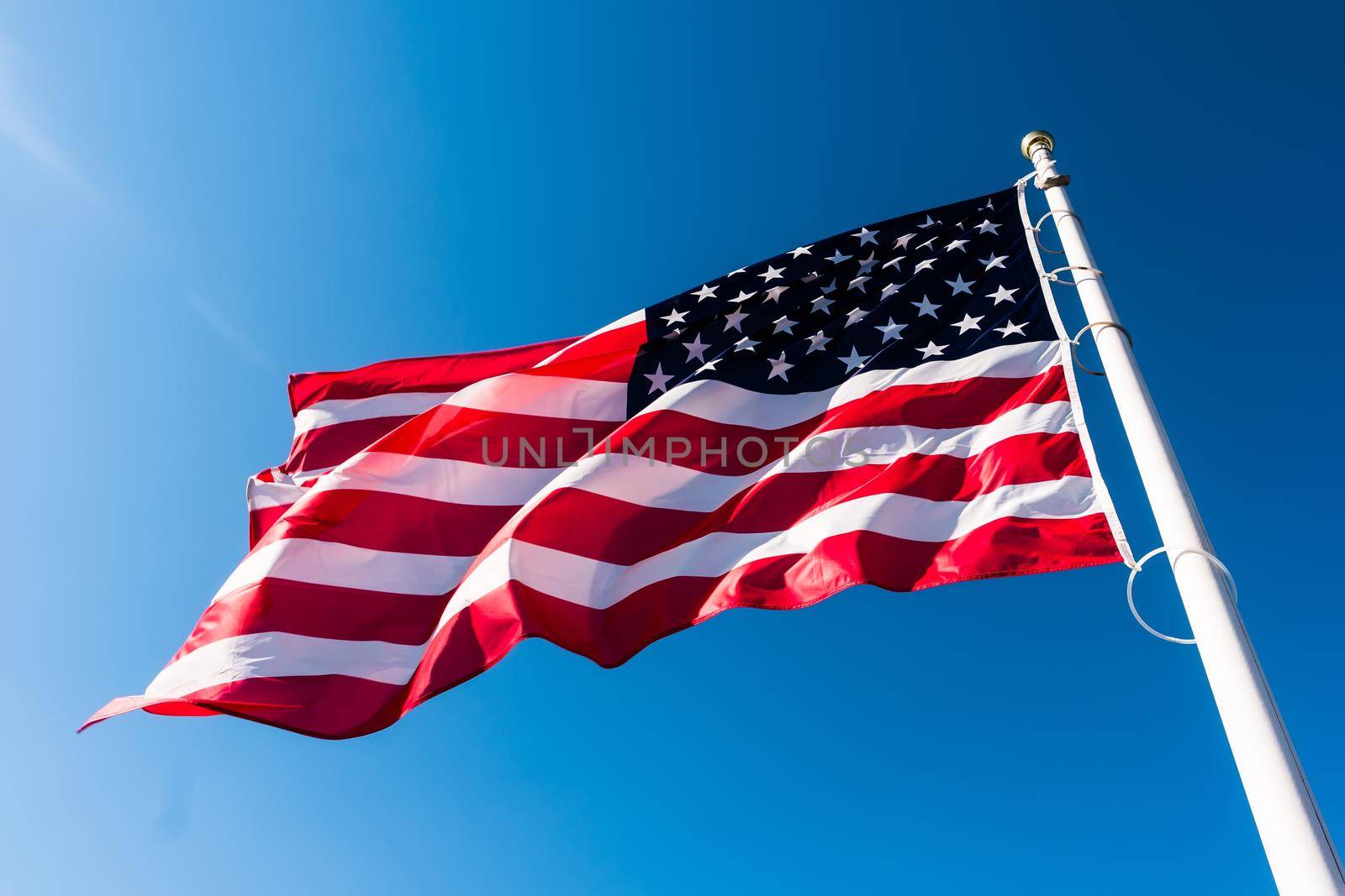 american flag waving in blue sky