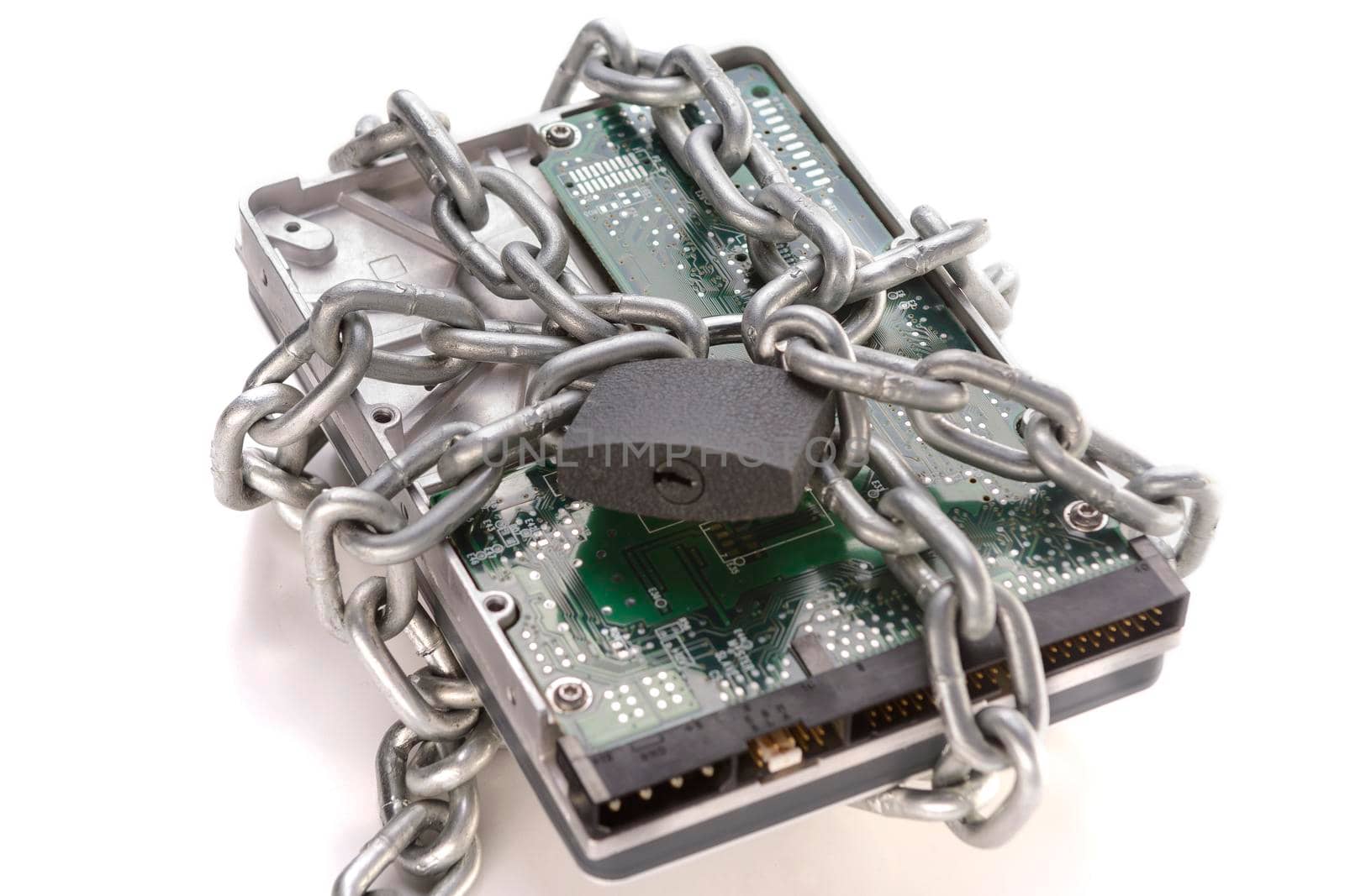 Metal chain and lock around hard disc drive on white. Secure data. Focusing on the center of the chain