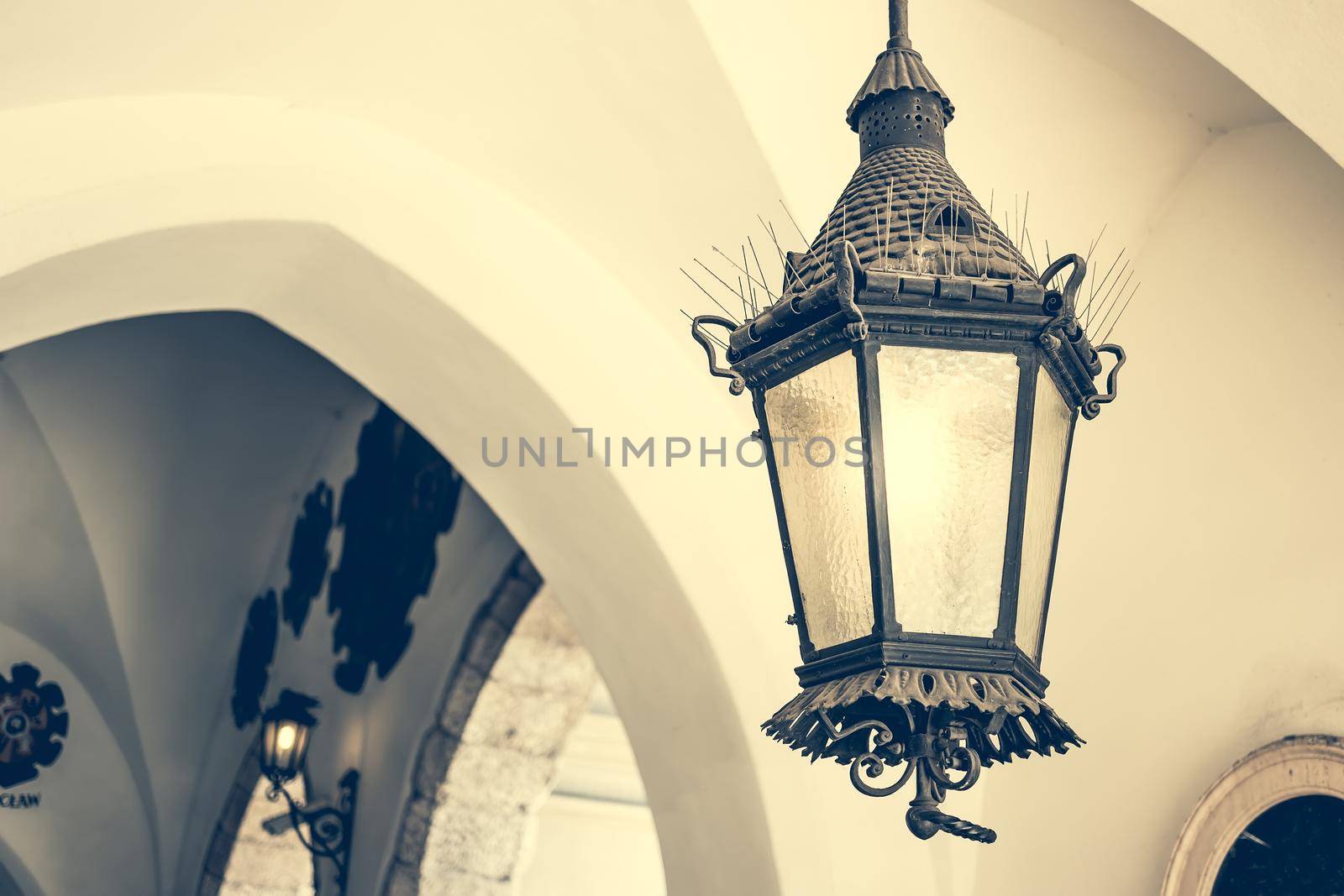 old ceiling lantern in old building with arches