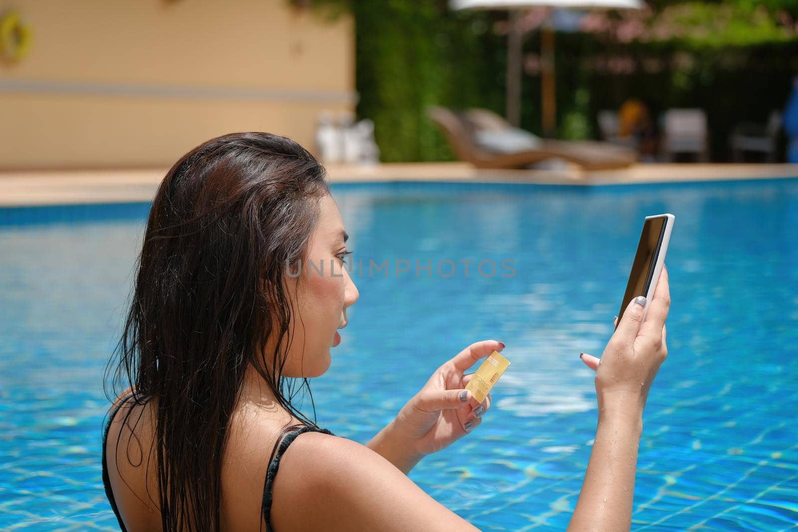 online payment, A teenage girl who swims is using her smartphone with her credit card to make purchases. online via internet