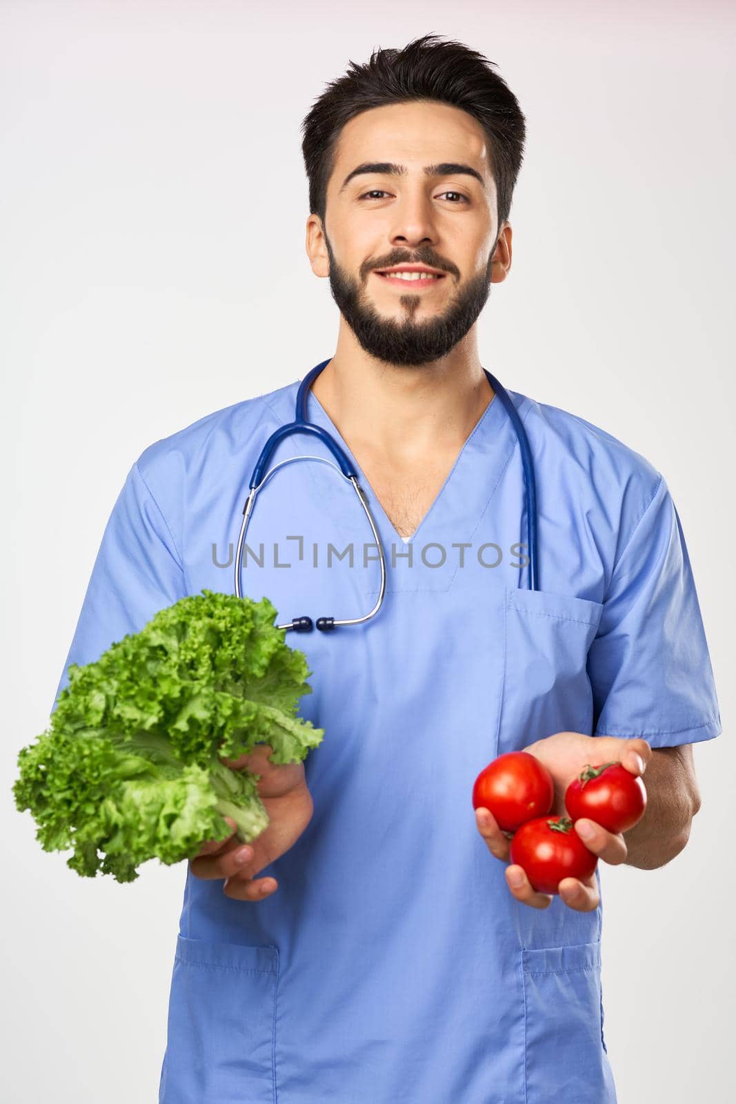 male doctor nutritionist with vegetables in hands healthy food by Vichizh