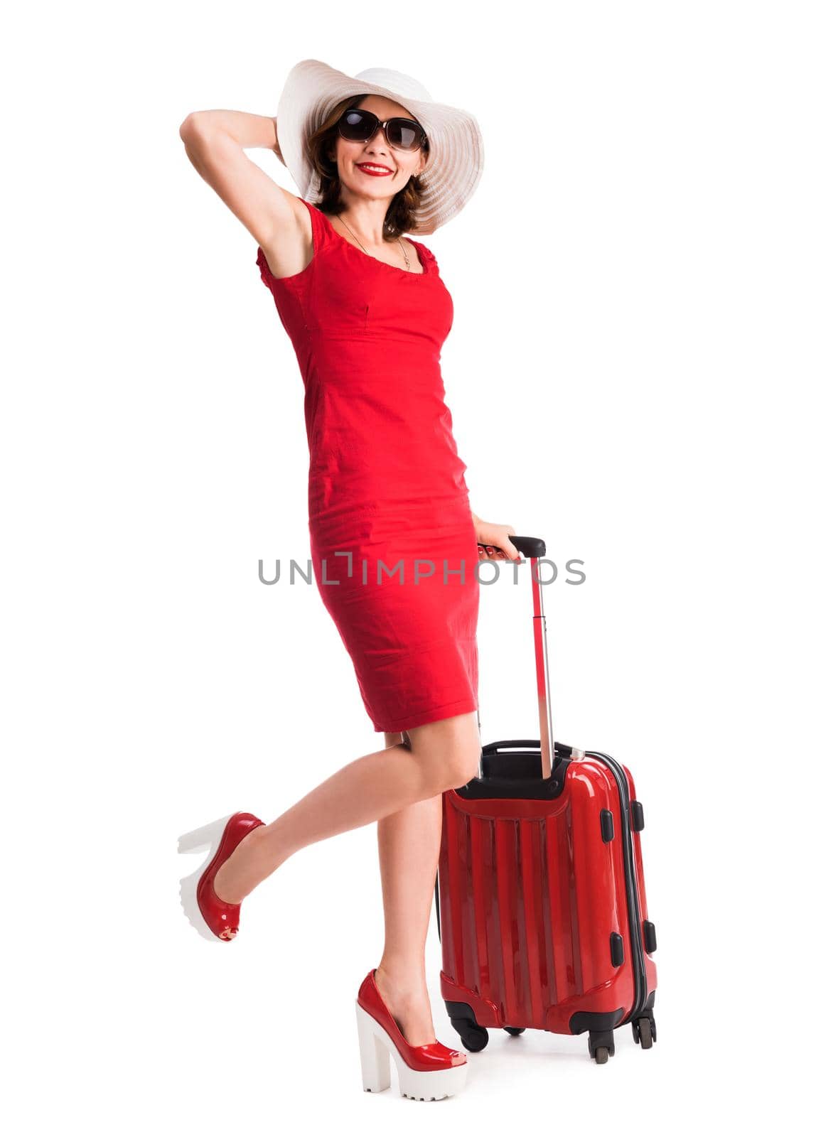 beautiful girl with red suitcase and hat going on vacation