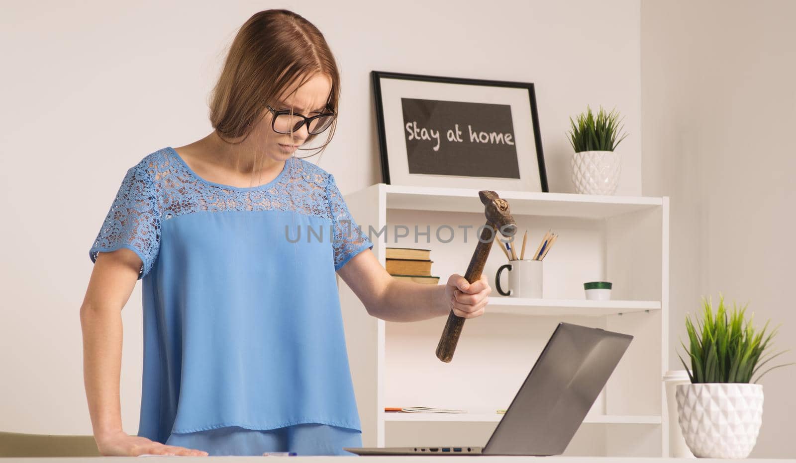 angry businesswoman went mad with hammer and laptop by zartarn