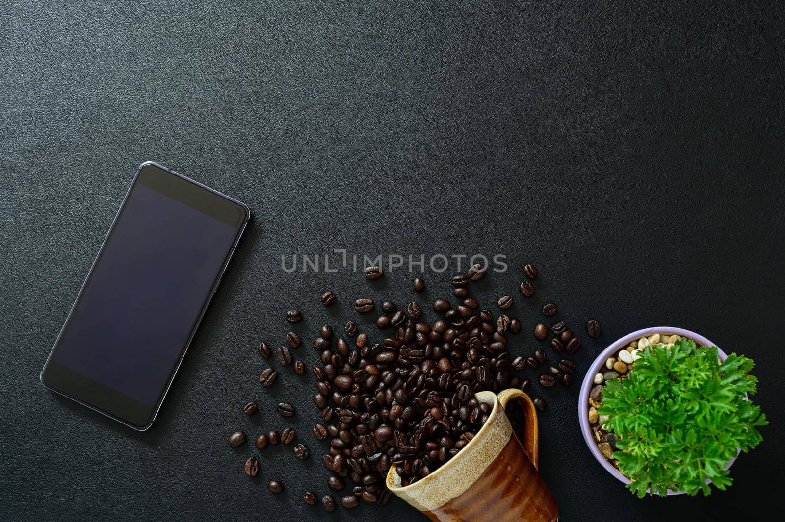  smartphone and coffee beans on the desk, top view