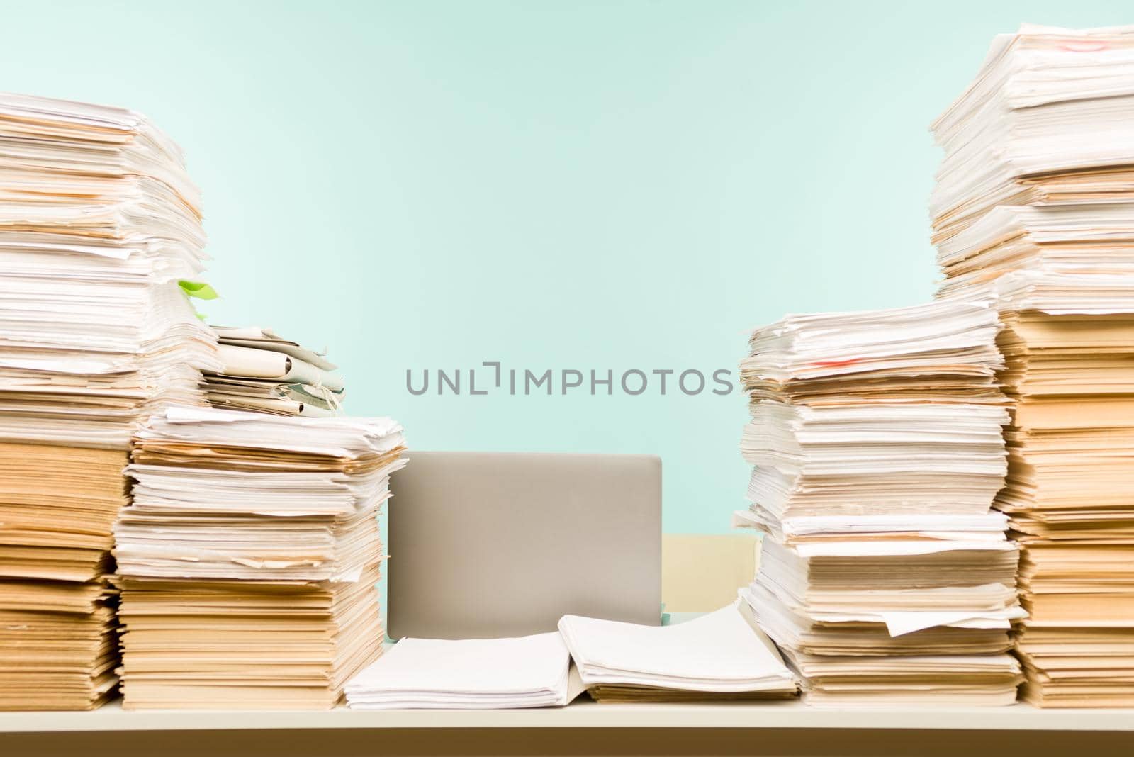 Stack of paper on desktop in office. -image