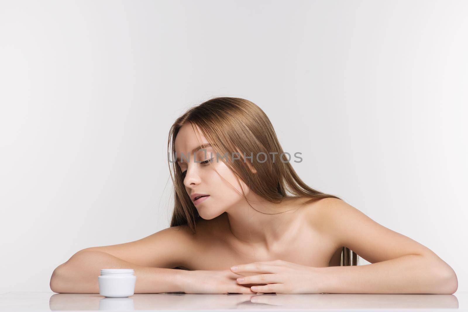 Beautiful spa girl with jar of cream isolated on white background - Image