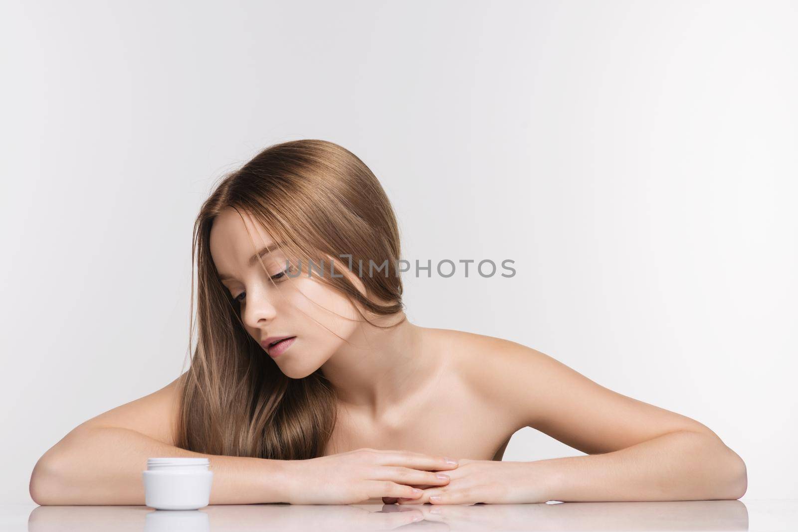 Beautiful spa girl with jar of cream isolated on white background - Image