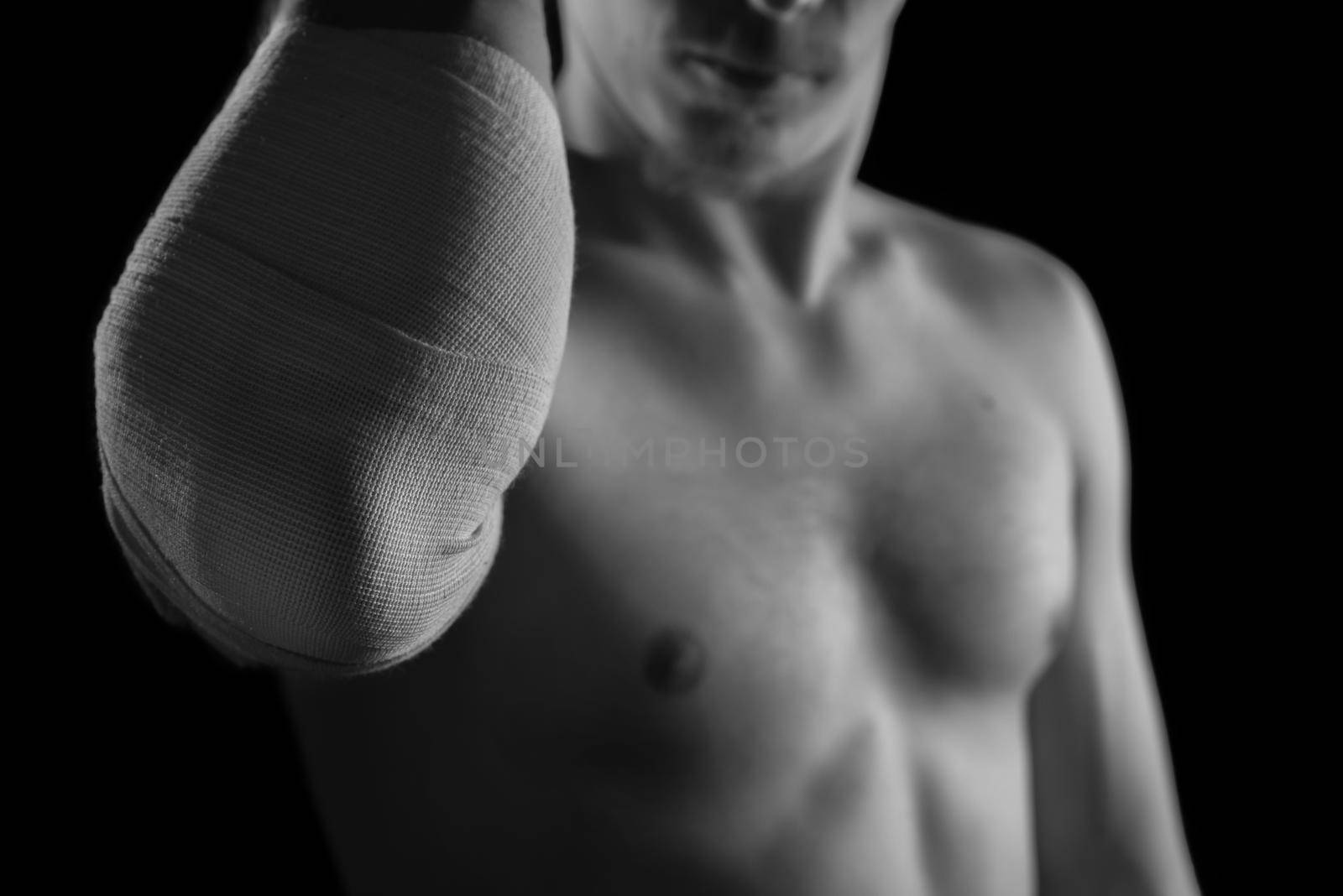 Bandaged male elbow joint, sprain, monochrome image