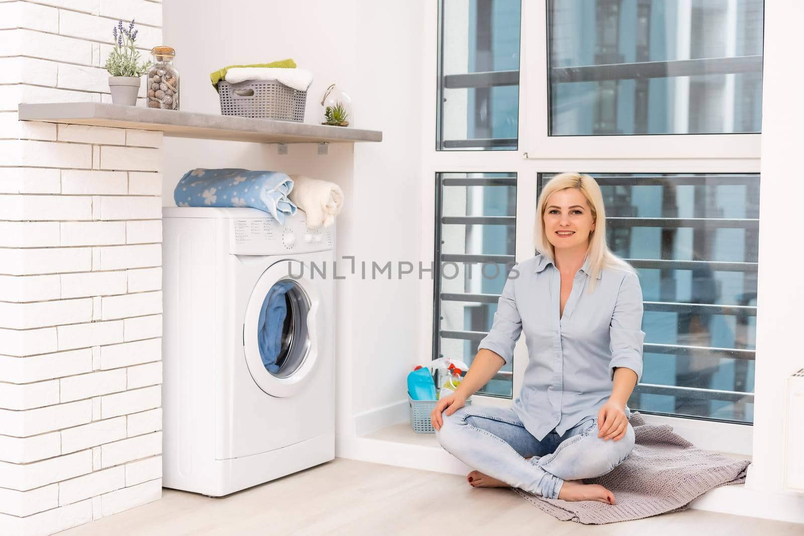 Housework, young woman doing laundry