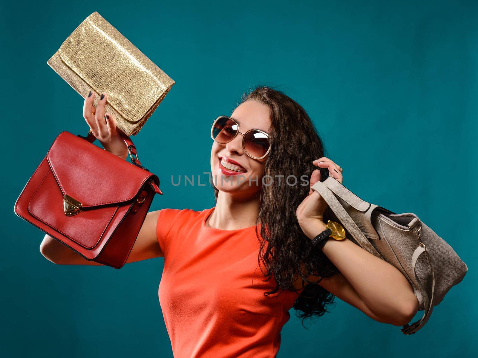 Fashion woman portrait isolated. Happy girl hold bags. Red dress. female beautiful model.