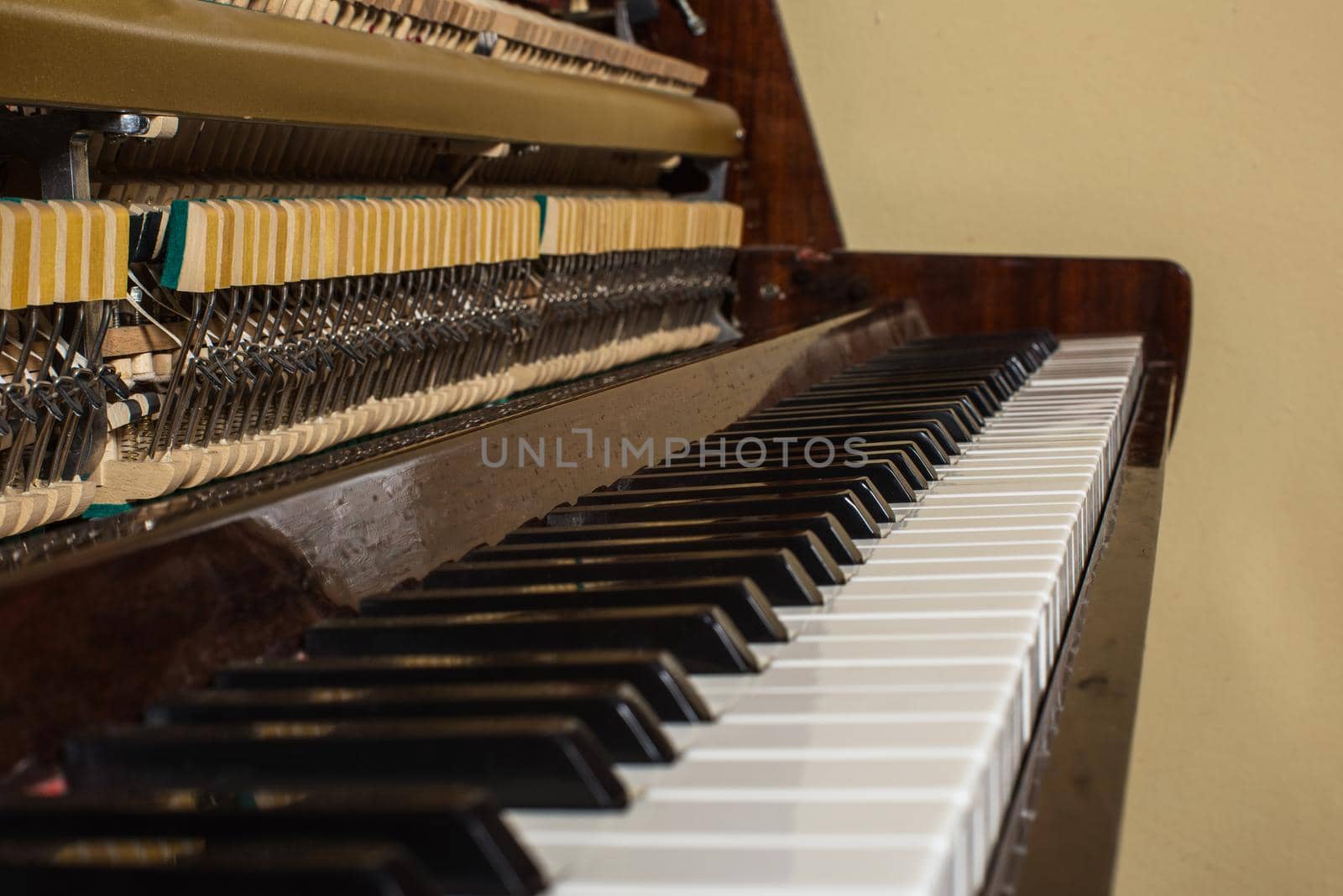 Piano keyboard background with selective focus. Warm color toned image